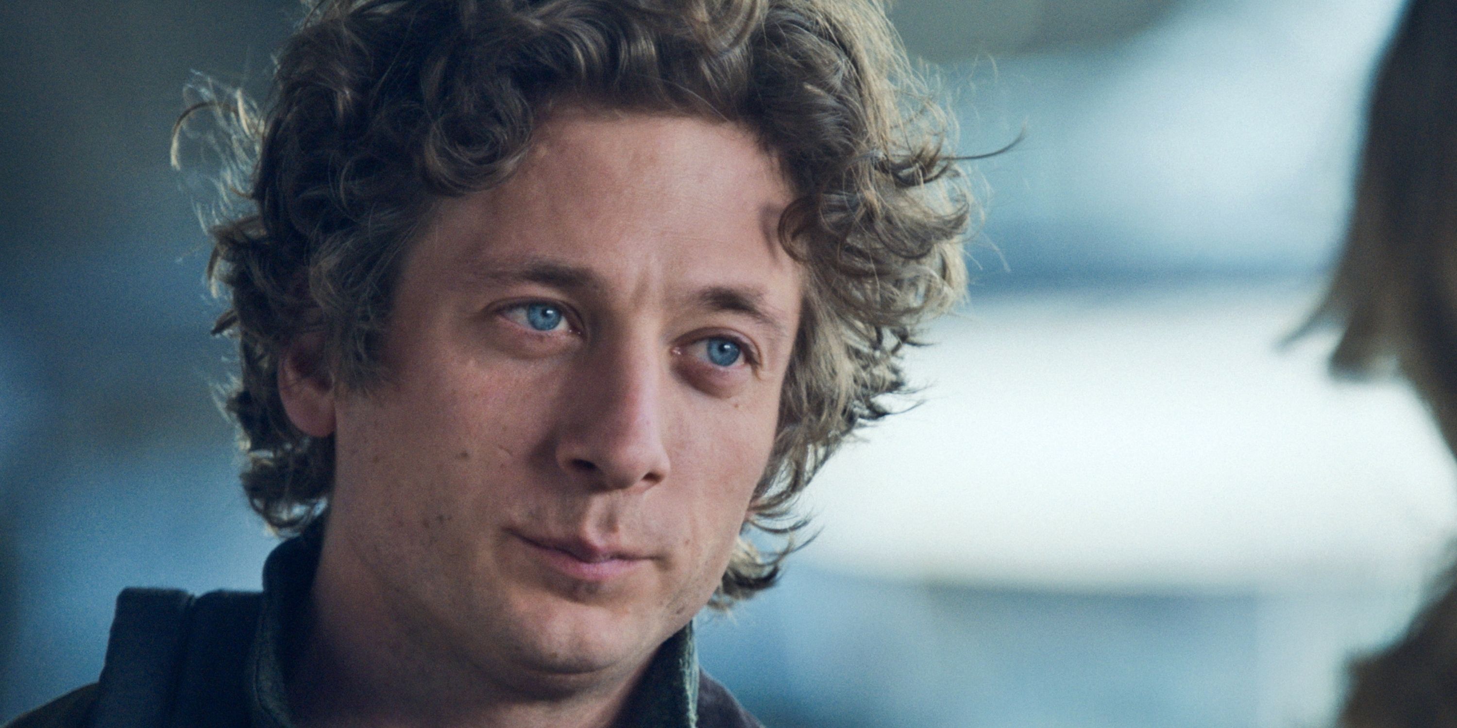 Jeremy Allen White as Carmen "Carmy" Barzatto in close-up standing across from someone in The Bear