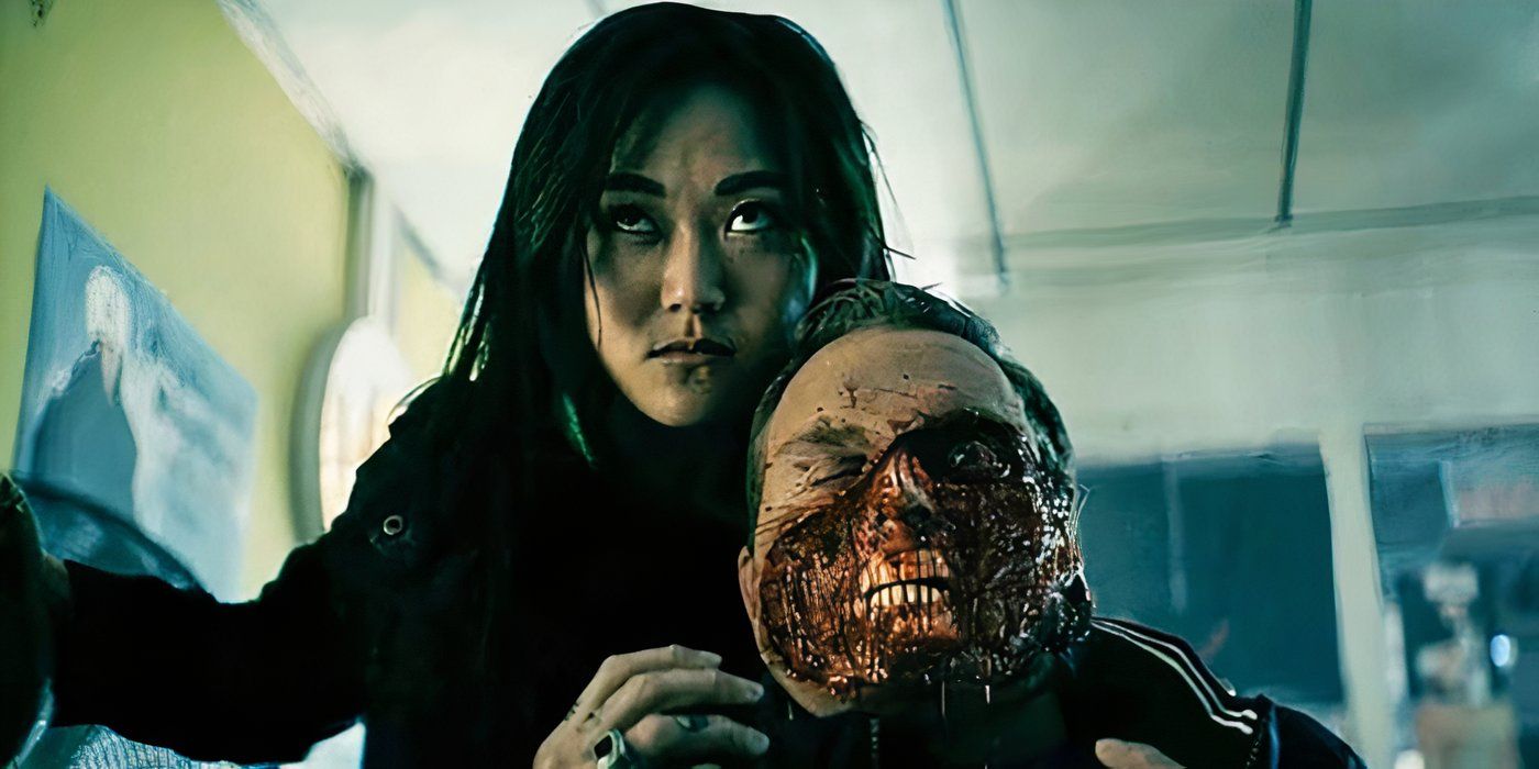 Kimiko with her arm around a man&rsquo;s neck, his face half ripped off in a scene from The Boys.