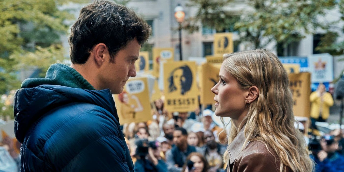 Jack Quaid and Erin Moriarty standing next to a Starlight vs. Homelander protest in The Boys Season 4