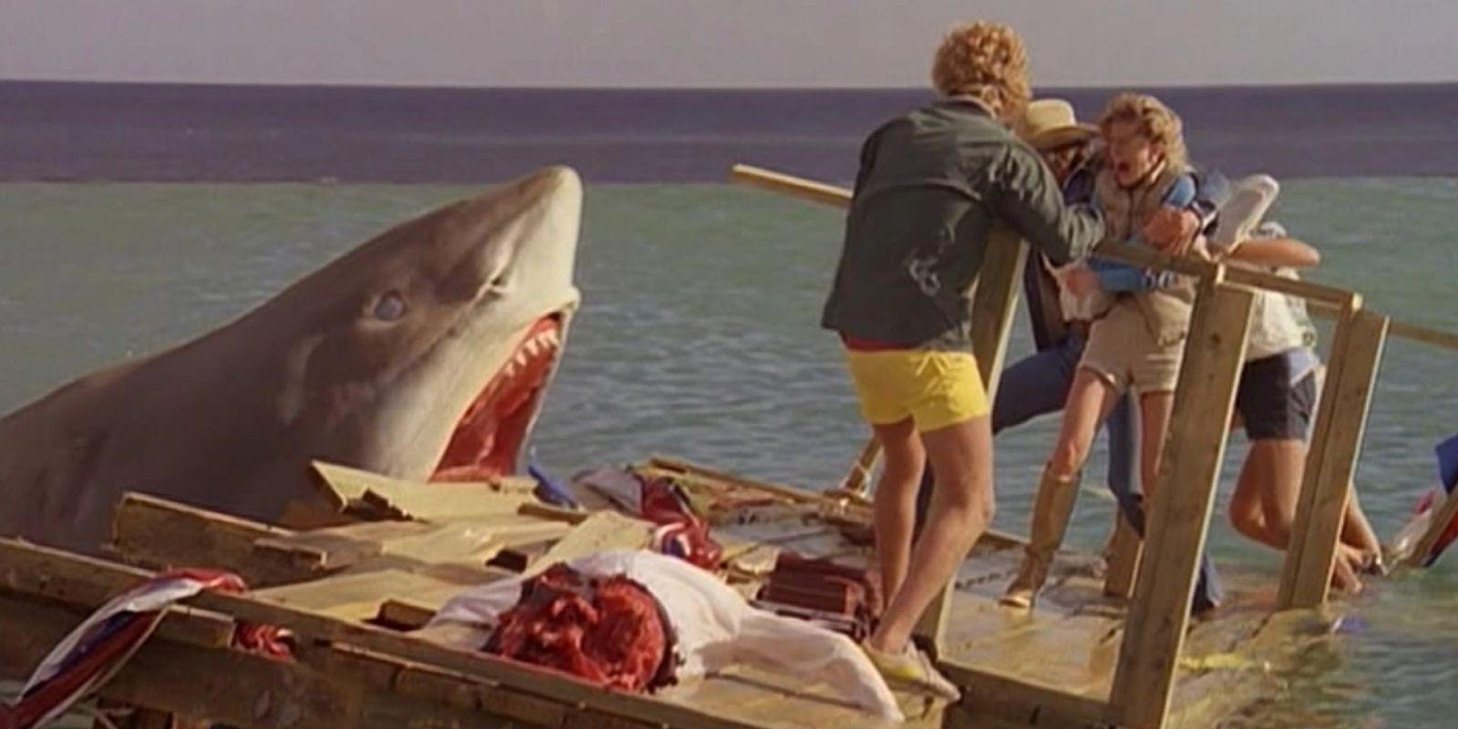 A shark launches from the water to attack people on a collapsing pier