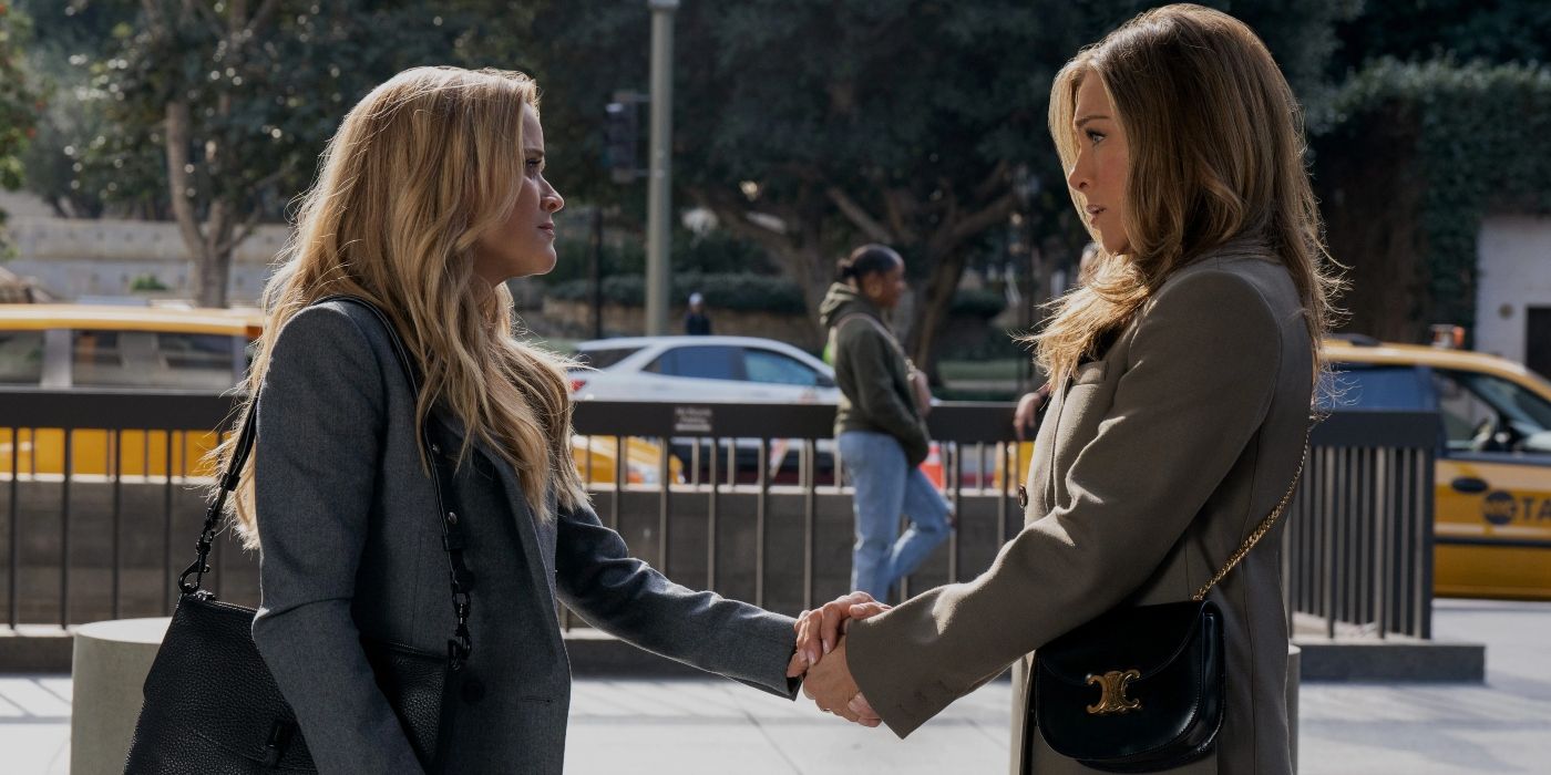 Bradley and Alex shake hands outside on a sidewalk in "The Morning Show".