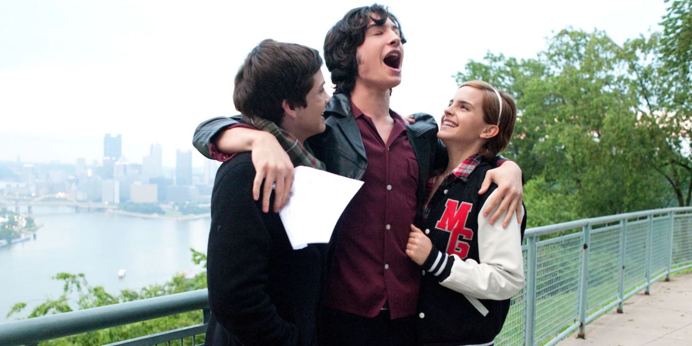 Patrick Stewart (Ezra Miller) embraces his friend Charlie (Logan Lerman) and his step sister Sam (Emma Watson) as the trio stand on a bridge overlooking the city in 'The Perks of Being a Wallflower' (2012).