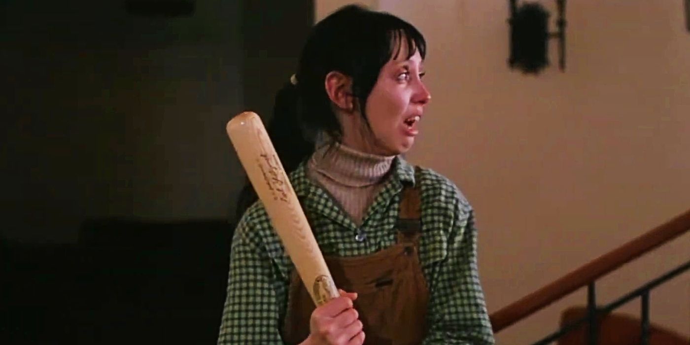 Wendy Torrance, played by actor Shelley Duvall, holds a baseball bat in terror on a staircase in The Shining