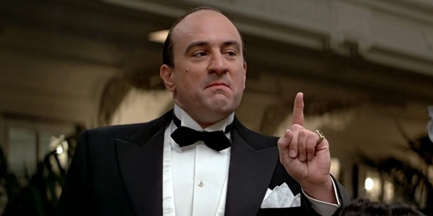 Al Capone stands in a tuxedo, raising his finger to make a point in 'The Untouchables' (1987).