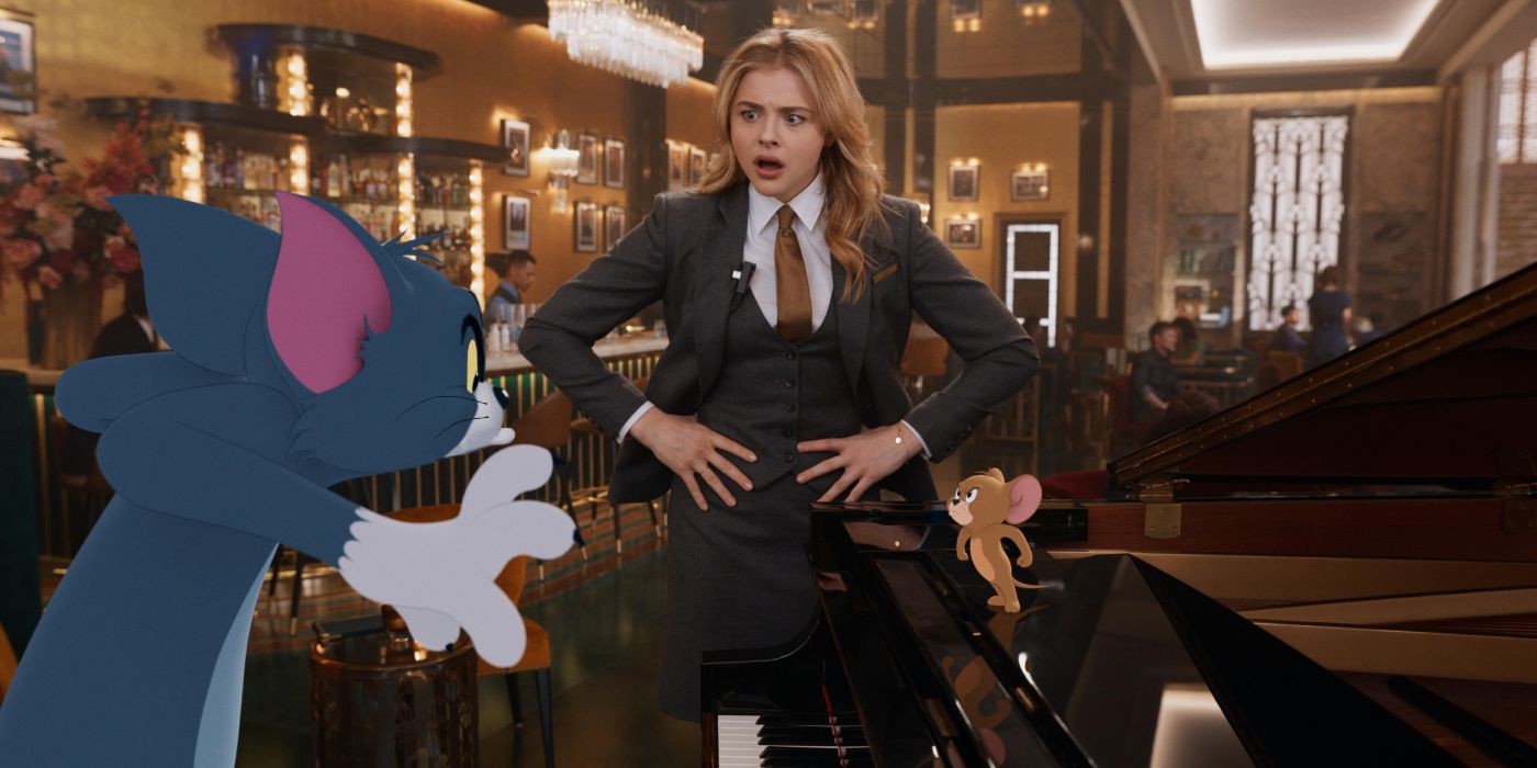 Young wedding planner Kayla (Chloë Grace Moretz) stands in a hotel lobby with her hands on her hips as Tom and Jerry scrap on a piano in 'Tom & Jerry' (2021).