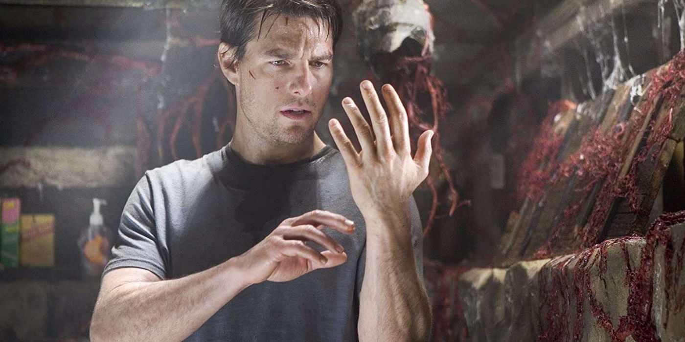 Ray Ferrier, played by Tom Cruise, stares at his hand with apprehension, uncertain what foreign material is coating it
