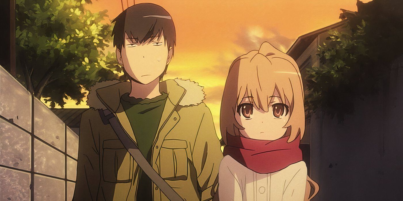 Two characters from Toradora wear jackets and walk side by side down a street.