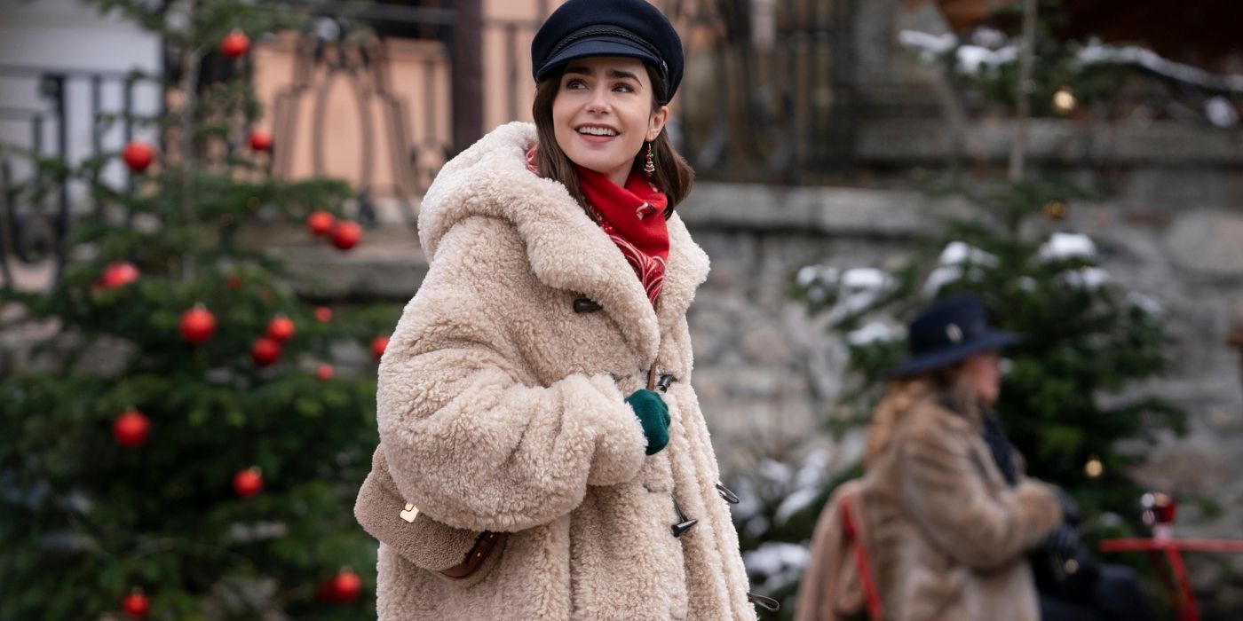 Lily Collins walking down a street decorated for the holidays in Emily in Paris Season 4