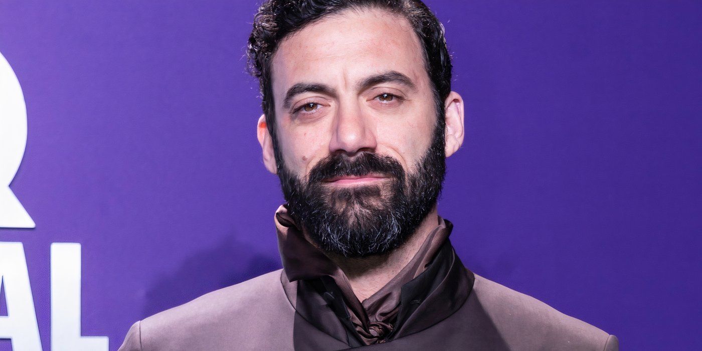 Morgan Spector in front of a purple background at an event