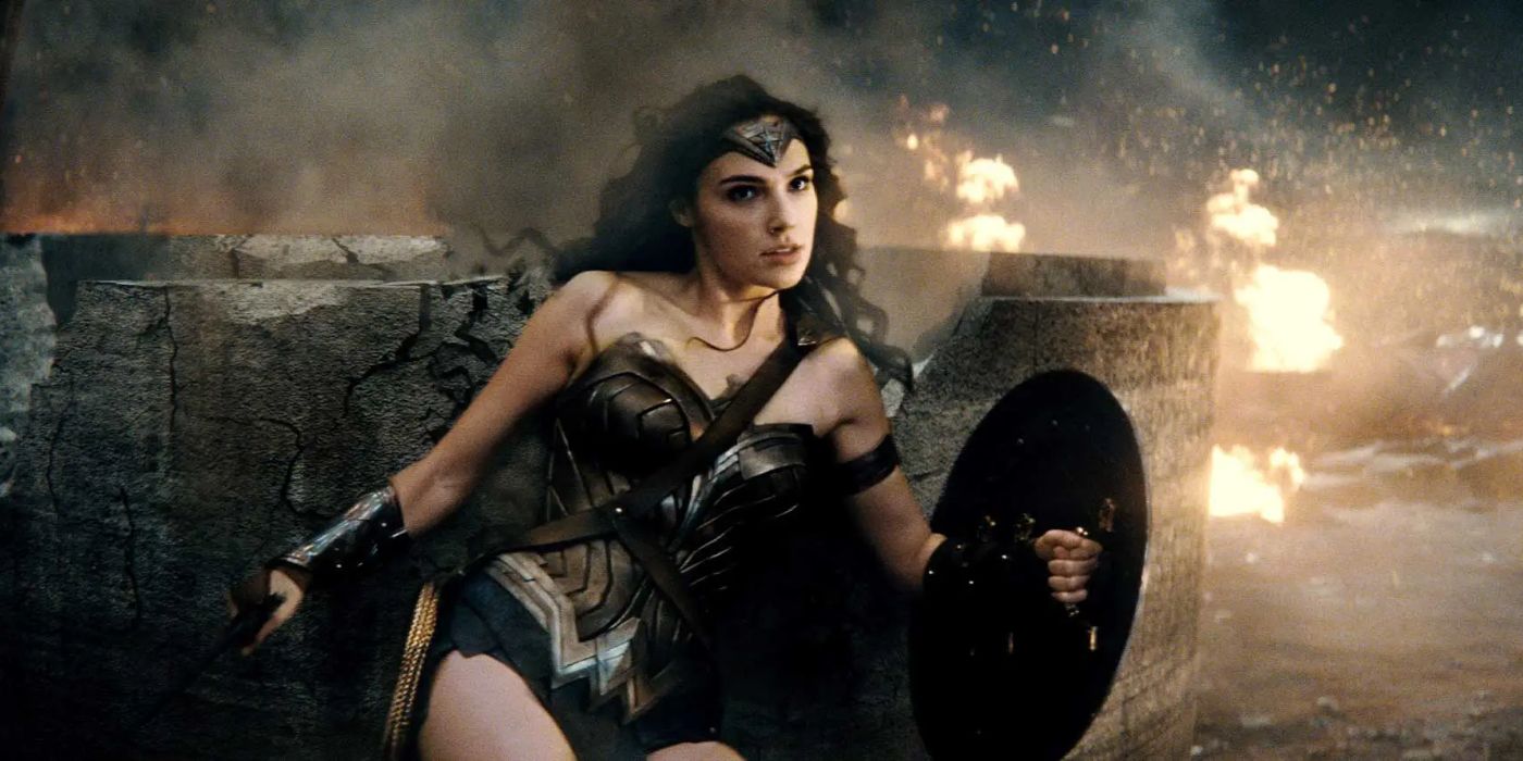 Wonder Woman (Gal Gadot) wields her shield as she is knocked against a concrete block in a fiery battlefield in &lsquo;Batman v Superman: Dawn of Justice&rsquo; (2016).