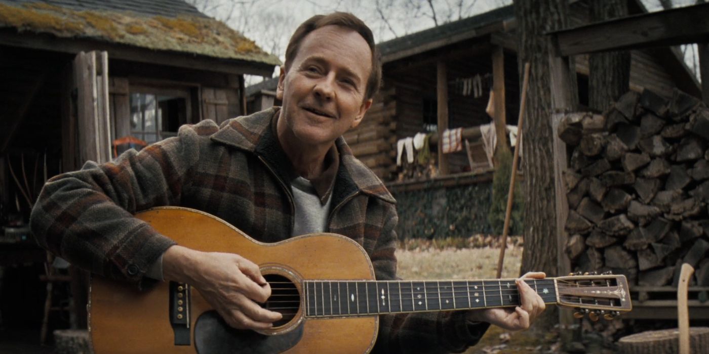 Edward Norton as Pete Seeger playing the guitar in A Complete Unknown.