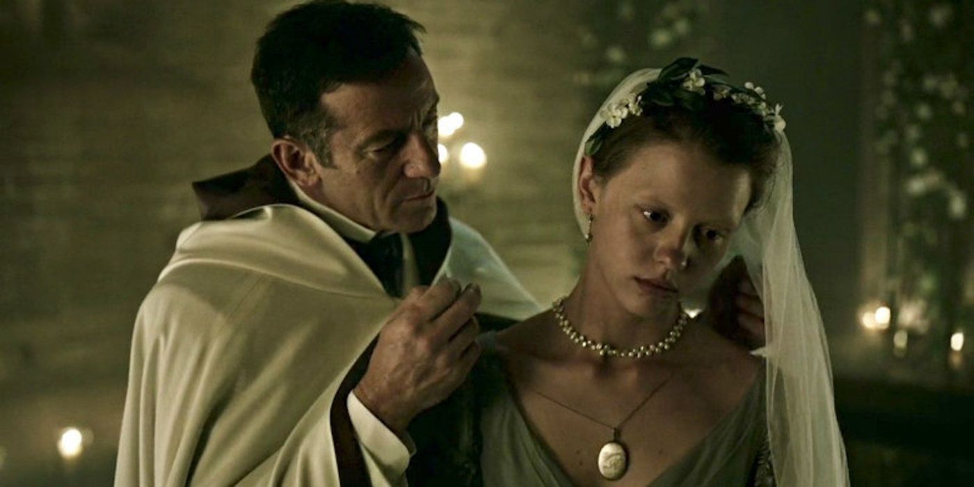A priest putting a necklace on a despondent bride in A Cure for Wellness