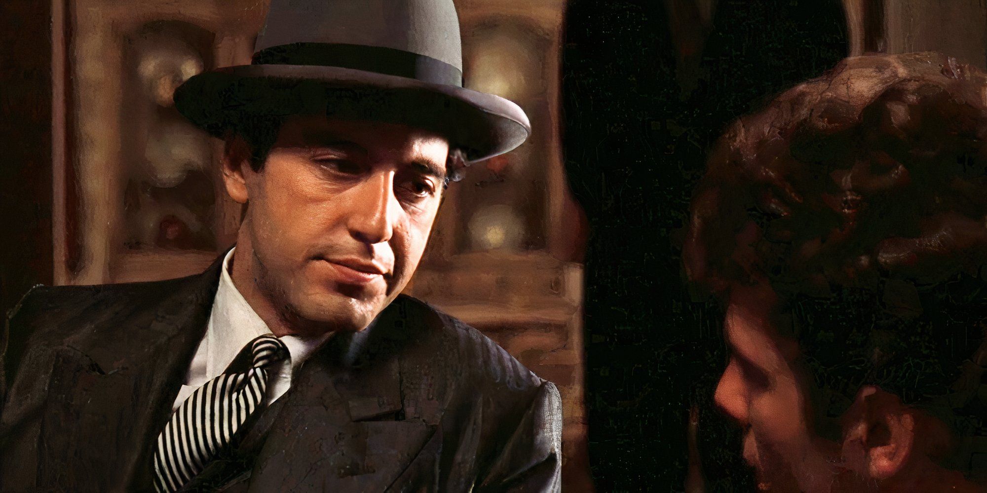 Al Pacino sitting next to Gianni Russo both looking at each other in The Godfather (1972)