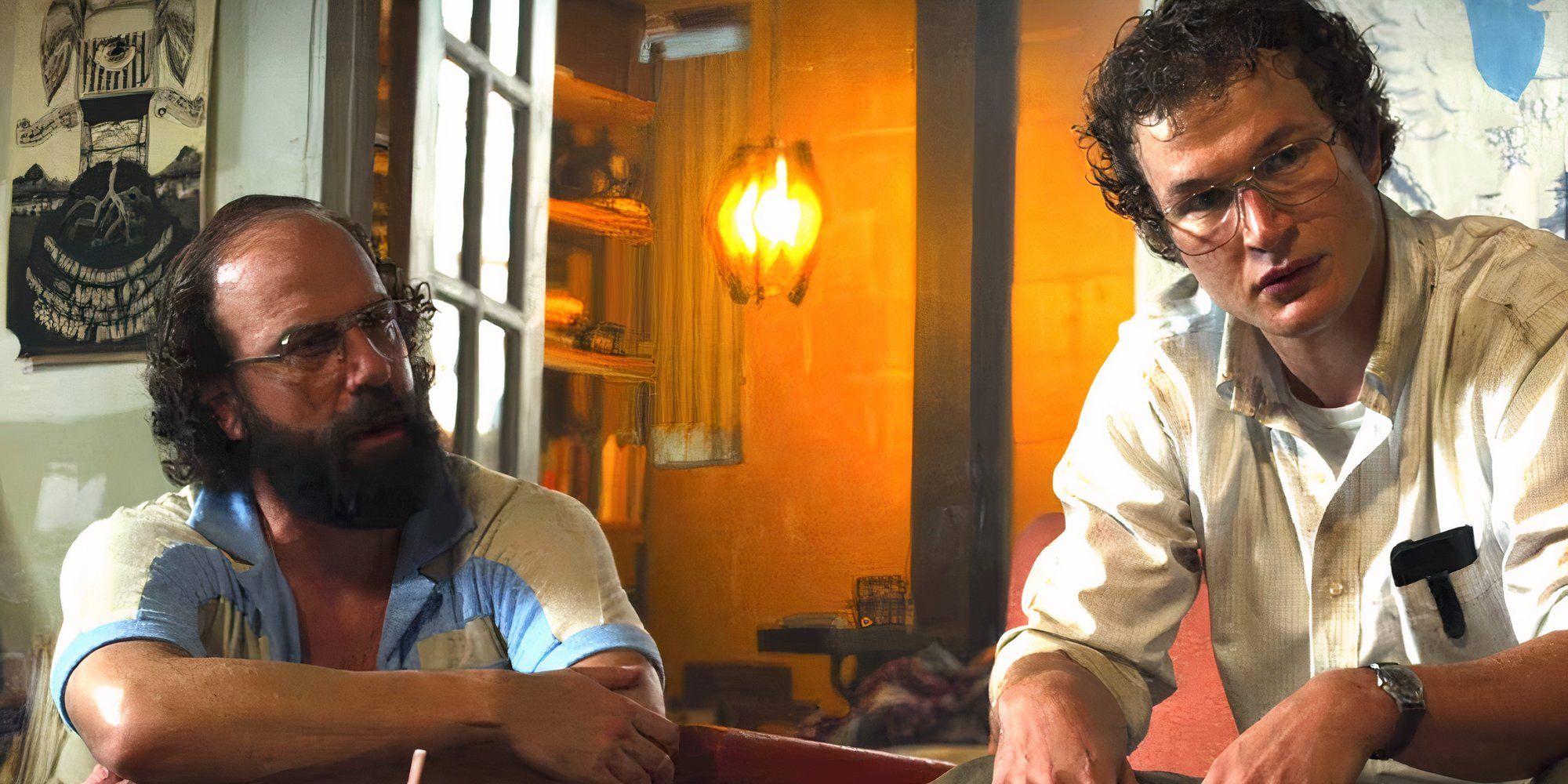 Alec Utgoff and Brett Gelman as Alexei and Murray in Stranger Things sitting side by side.