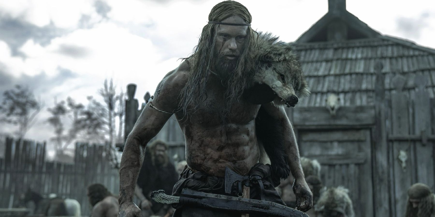 The Viking Amleth, played by Alexander Skarsgård, lumbers through a village, covered in blood in The Northman.