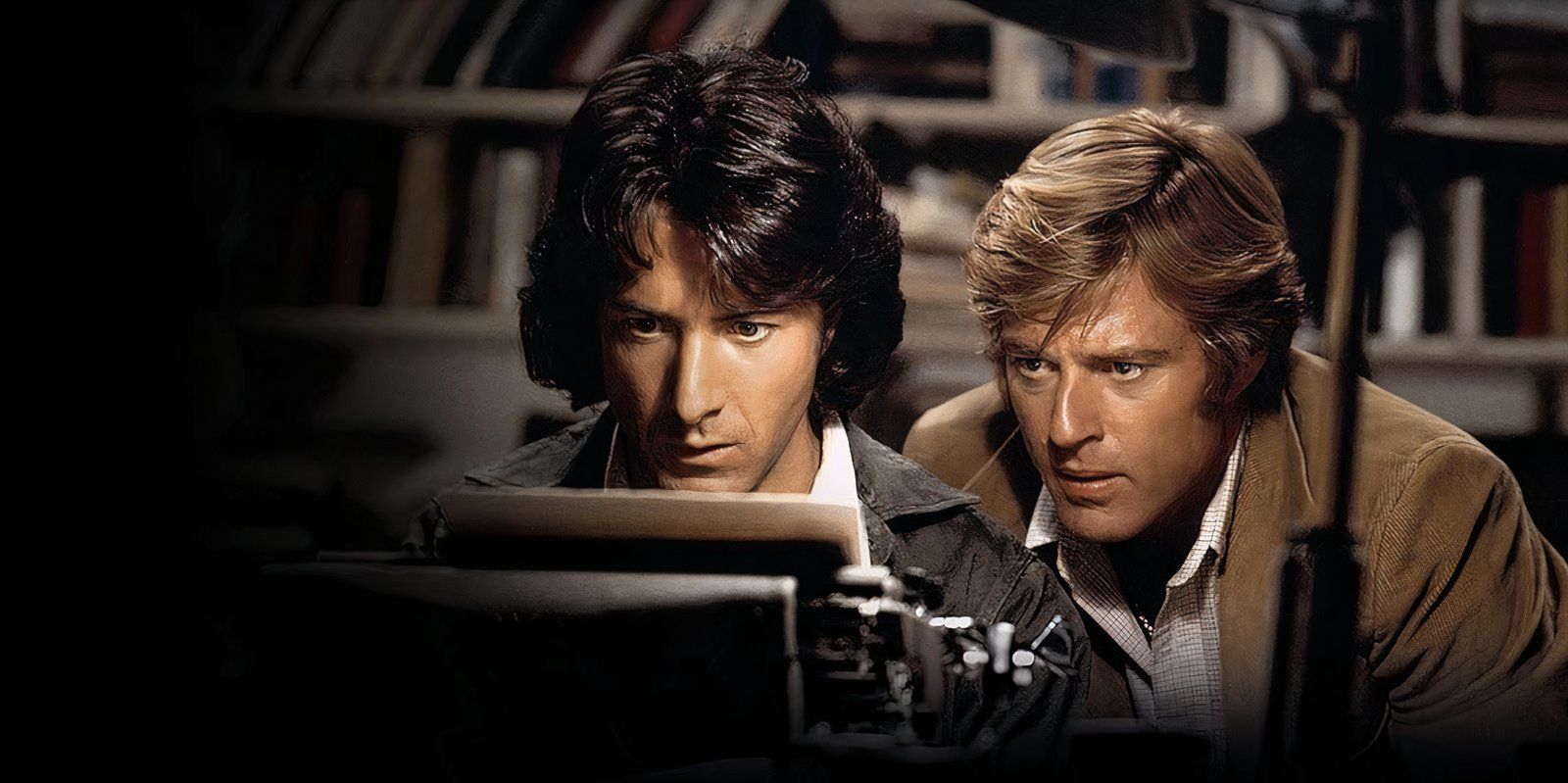 Dustin Hoffman and Robert Redford look intently at a typewriter in All the President's Men 1976