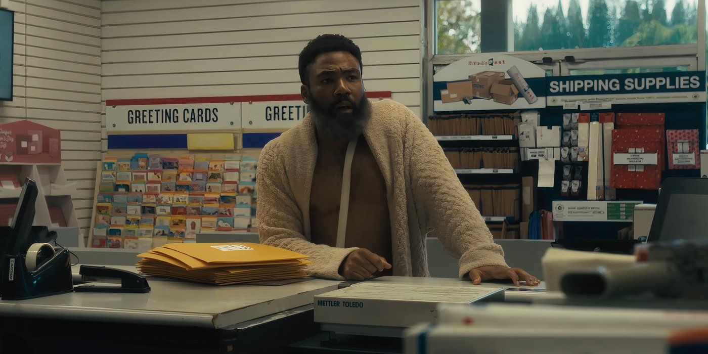 Donald Glover with a graying beard standing in an empty post office in Bando Stone and the New World.