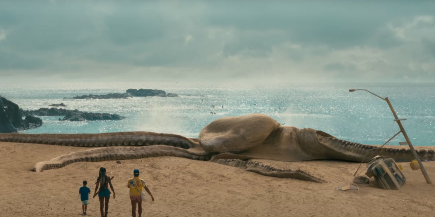 Donald Glover, Jessica Allain, and Legend Glover walking towards a washed-up sea monster