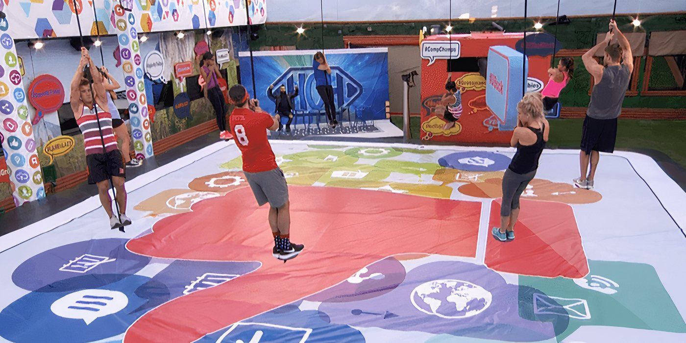 Several Big Brother players standing on small discs holding ropes rotating in circles.