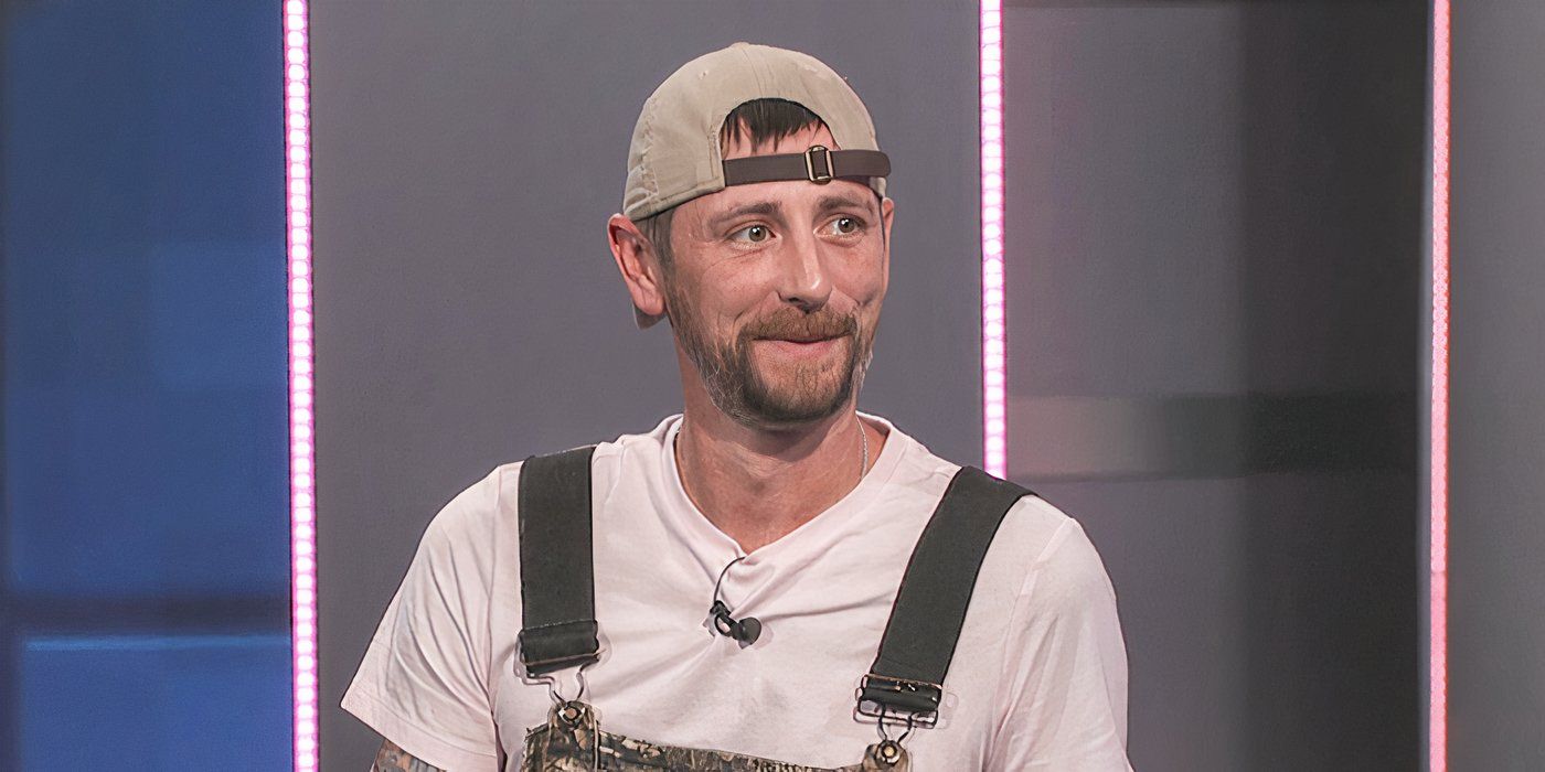 Frenchie from Big Brother wearing a hat backwards and overalls talking to Julie Chen.