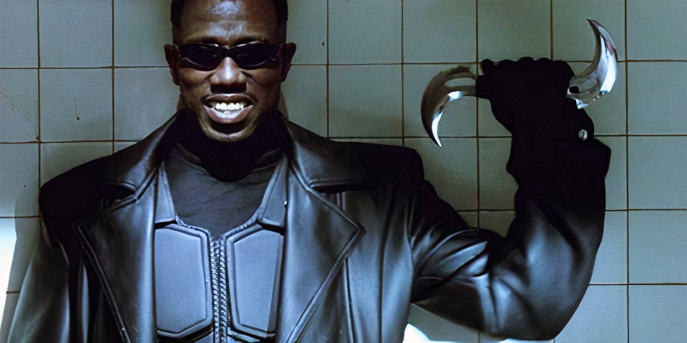 Blade, played by Wesley Snipes, smiles and holds up a double-sided throwing weapon