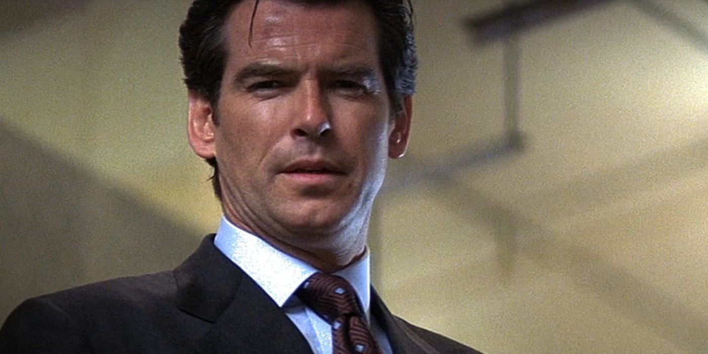 A dirtied and roughed-up James Bond (Pierce Brosnan) glares down with a slight frown in 'Tomorrow Never Dies' (1997).