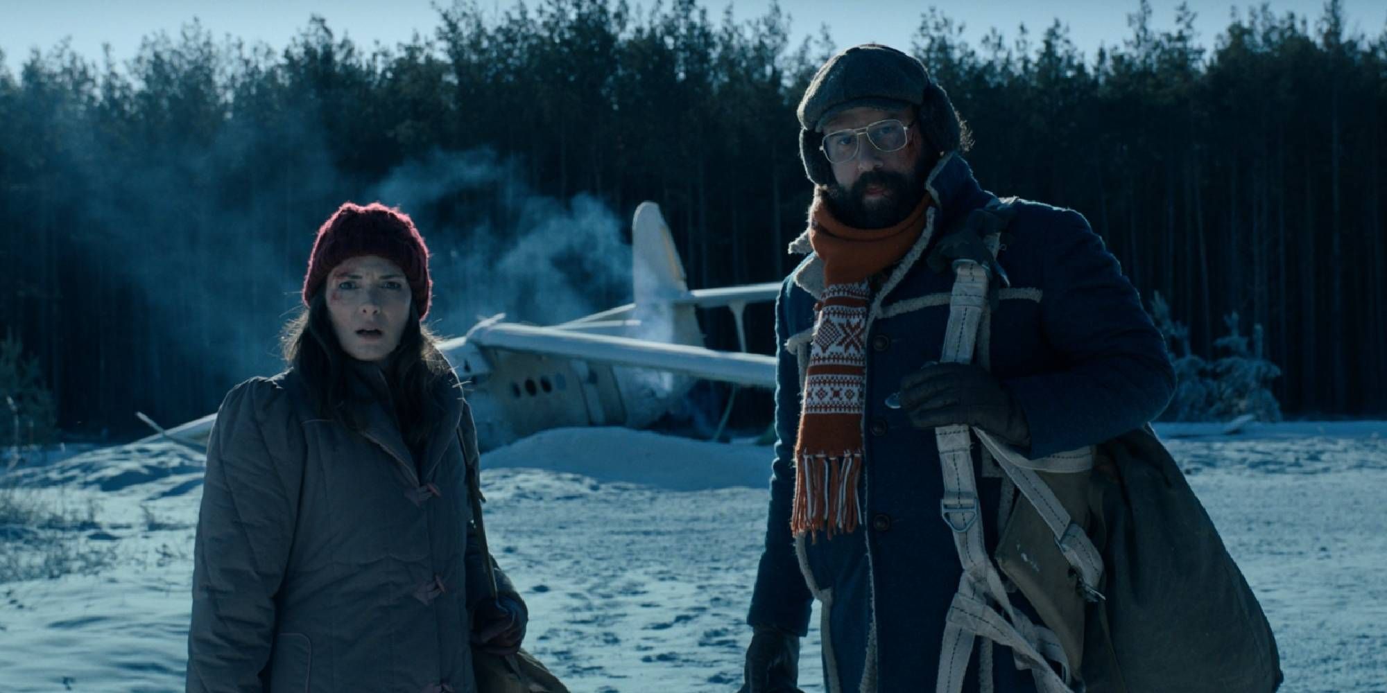 Brett Gelman as Murray and Winona Ryder as Joyce in Stranger Things standing on the snow.