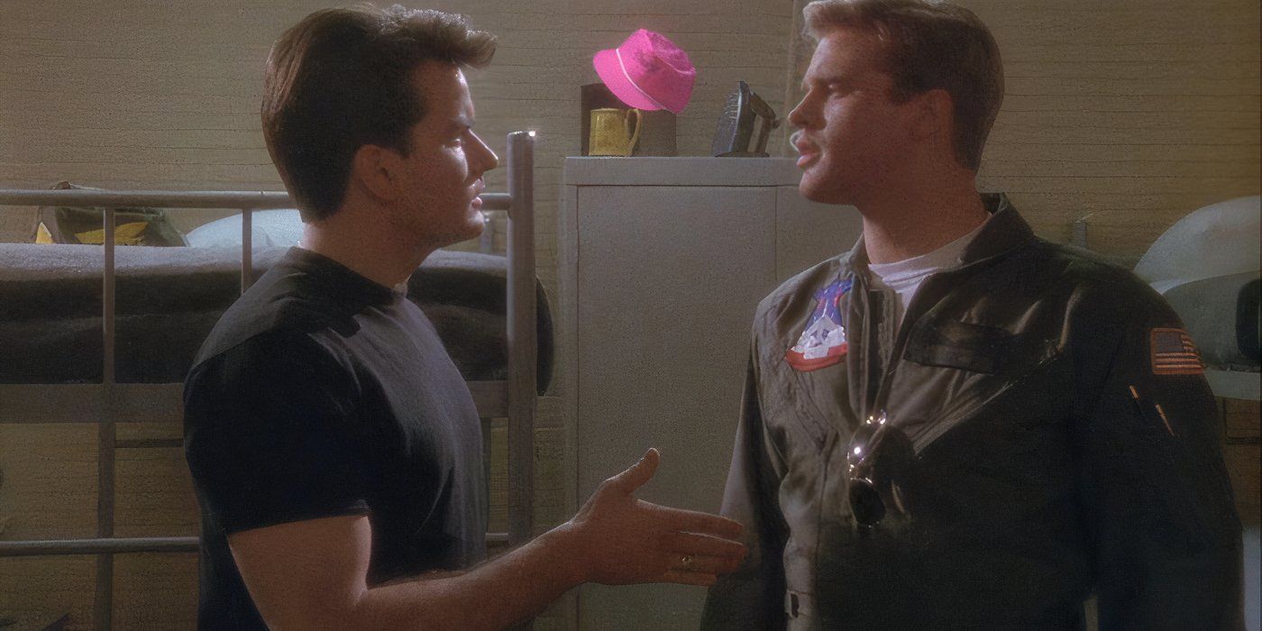 Cary Elwes and Charlie Sheen stand looking at each other in the bunks in Hot Shots! (1991)