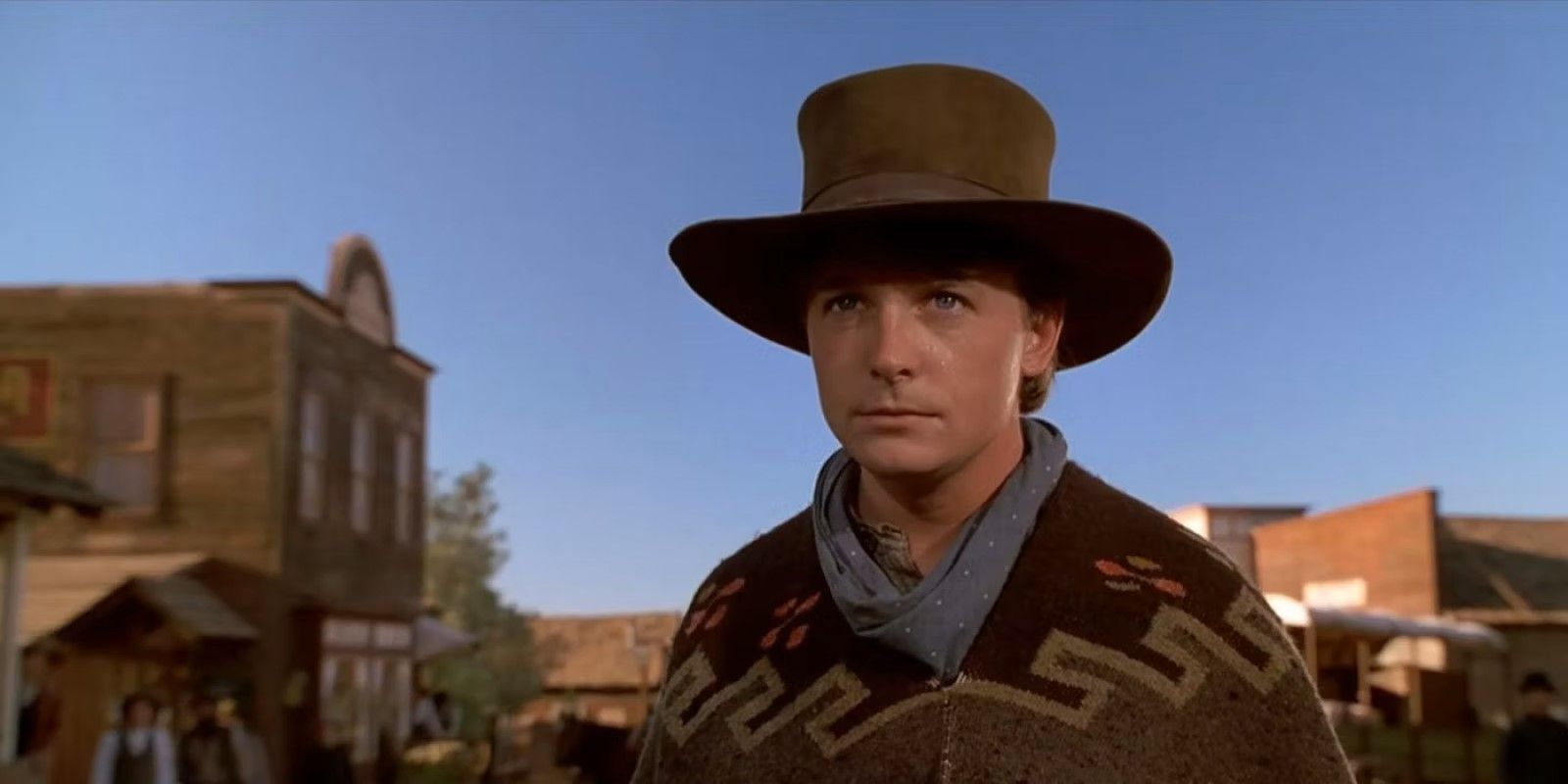 Marty McFly (Michael J. Fox) wearing a cowboy hat walking into town in 'Back to the Future Part III'