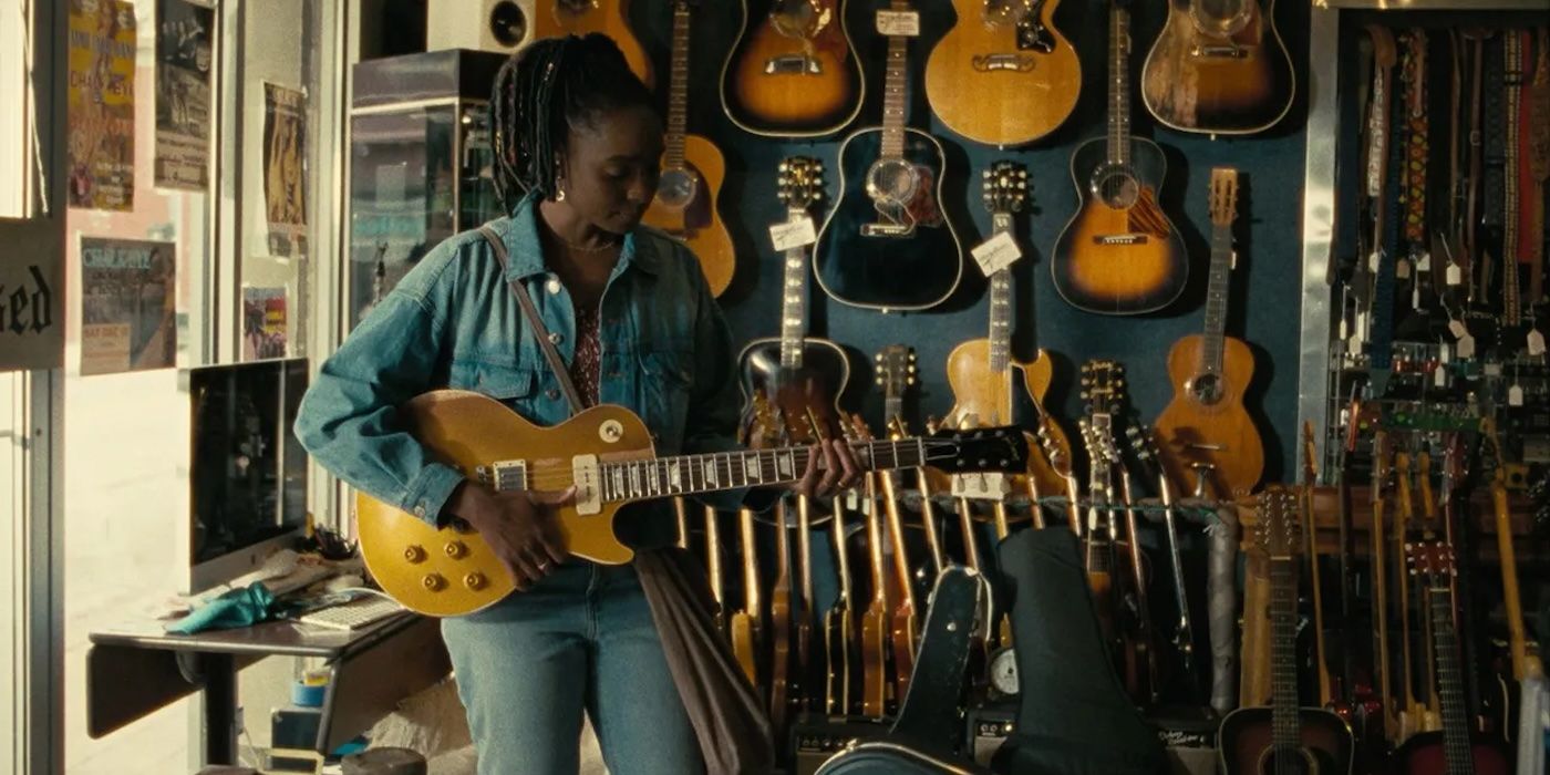Kiki Layne in Dandelion playing a guitar