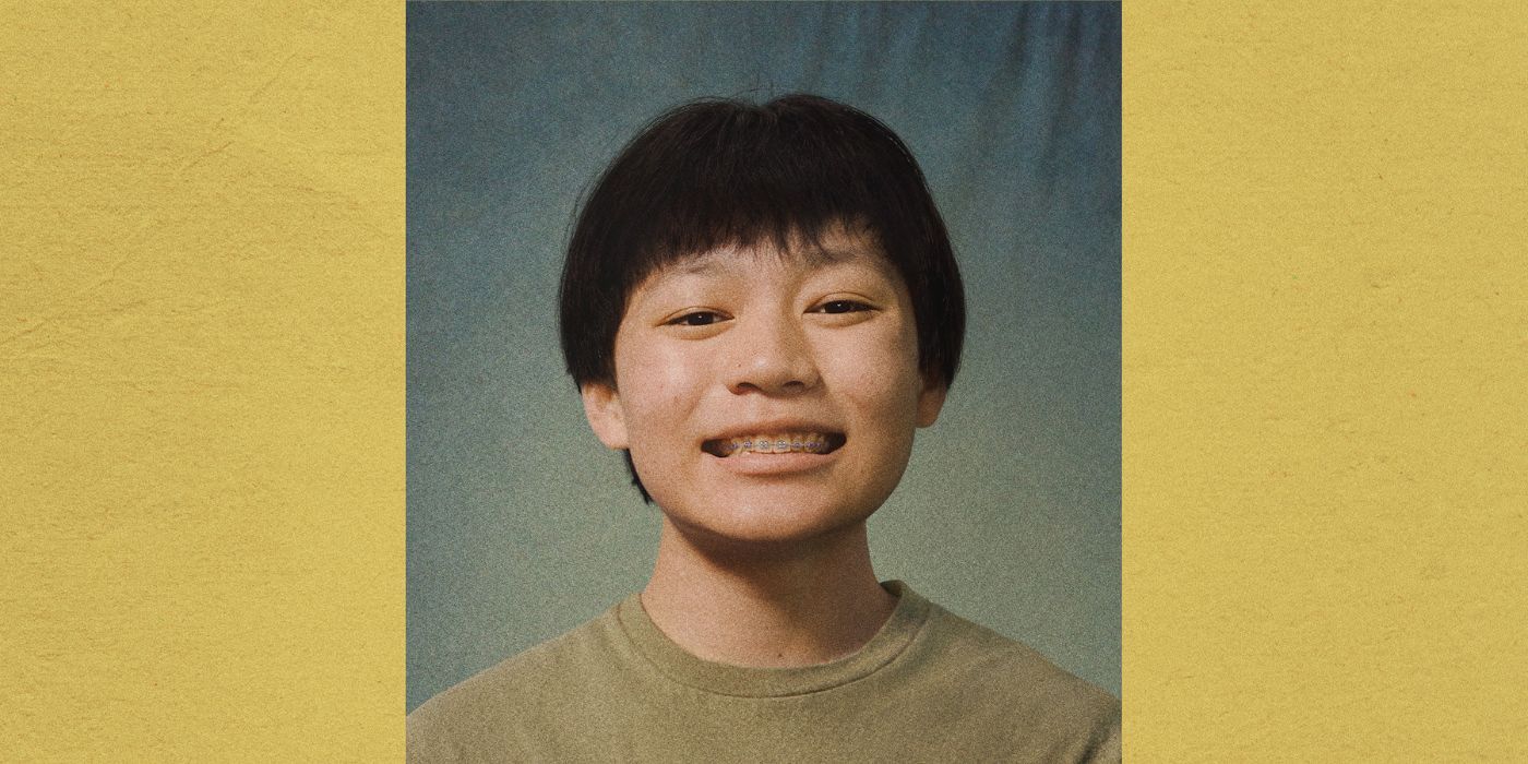 Izaac Wang smiling for a school photo on the poster for Didi.