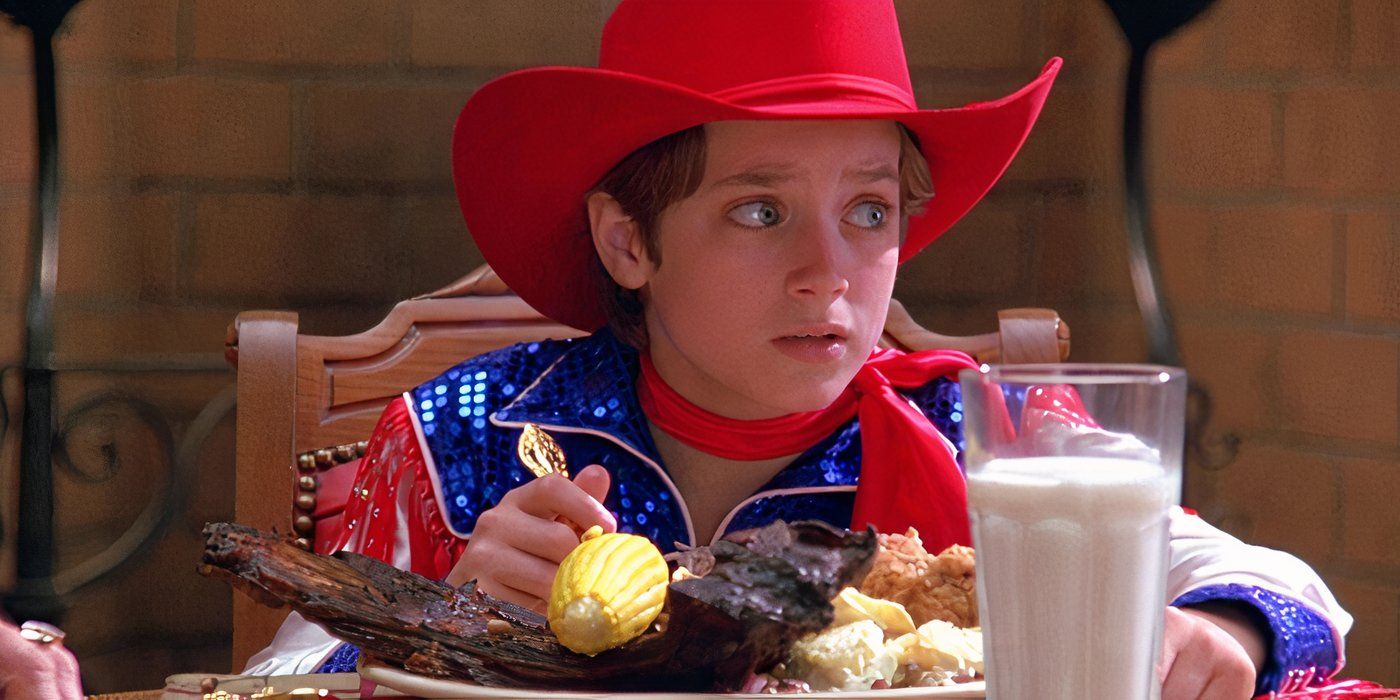 Elijah Wood wearing a red and blue cowboy outfit while eating a steak dinner in North 1994