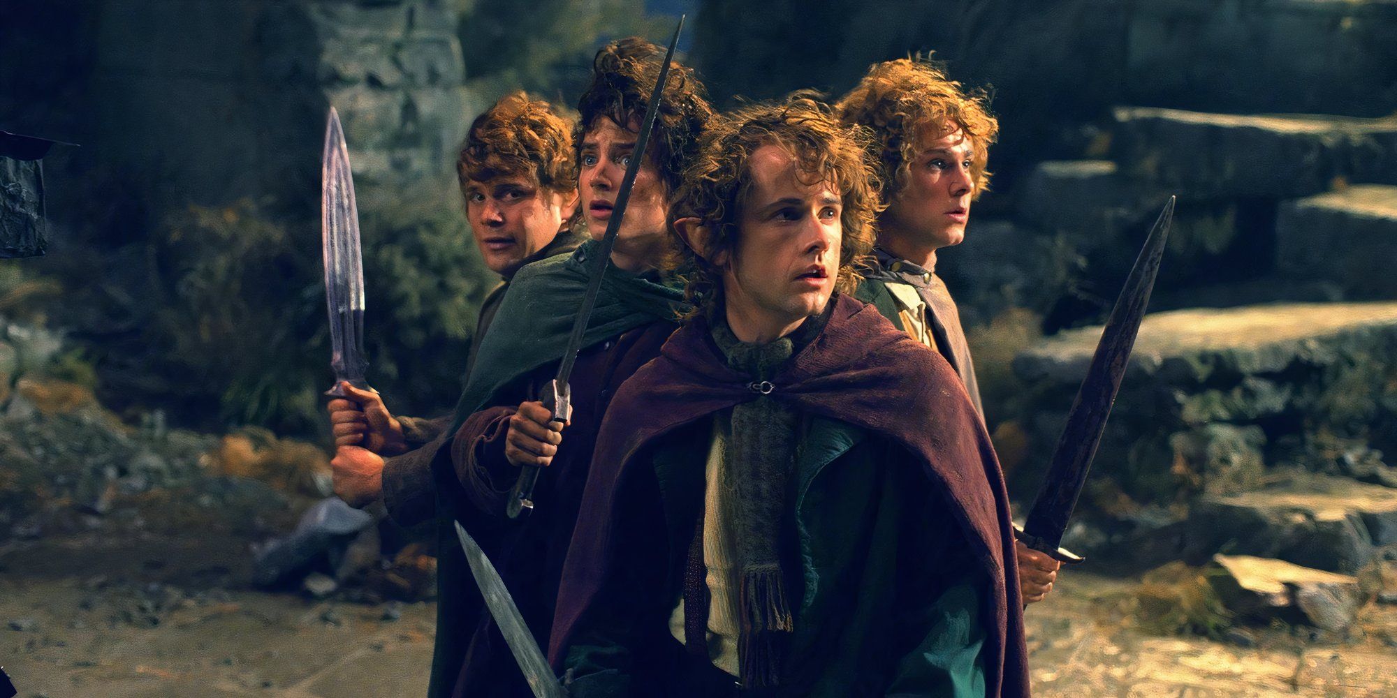 A still from 'The Fellowship of the Ring' of Sam (Sean Astin), Frodo (Elijah Wood), Pippin (Billy Boyd), and Merry (Dominic Monaghan) holding swords and looking determined.