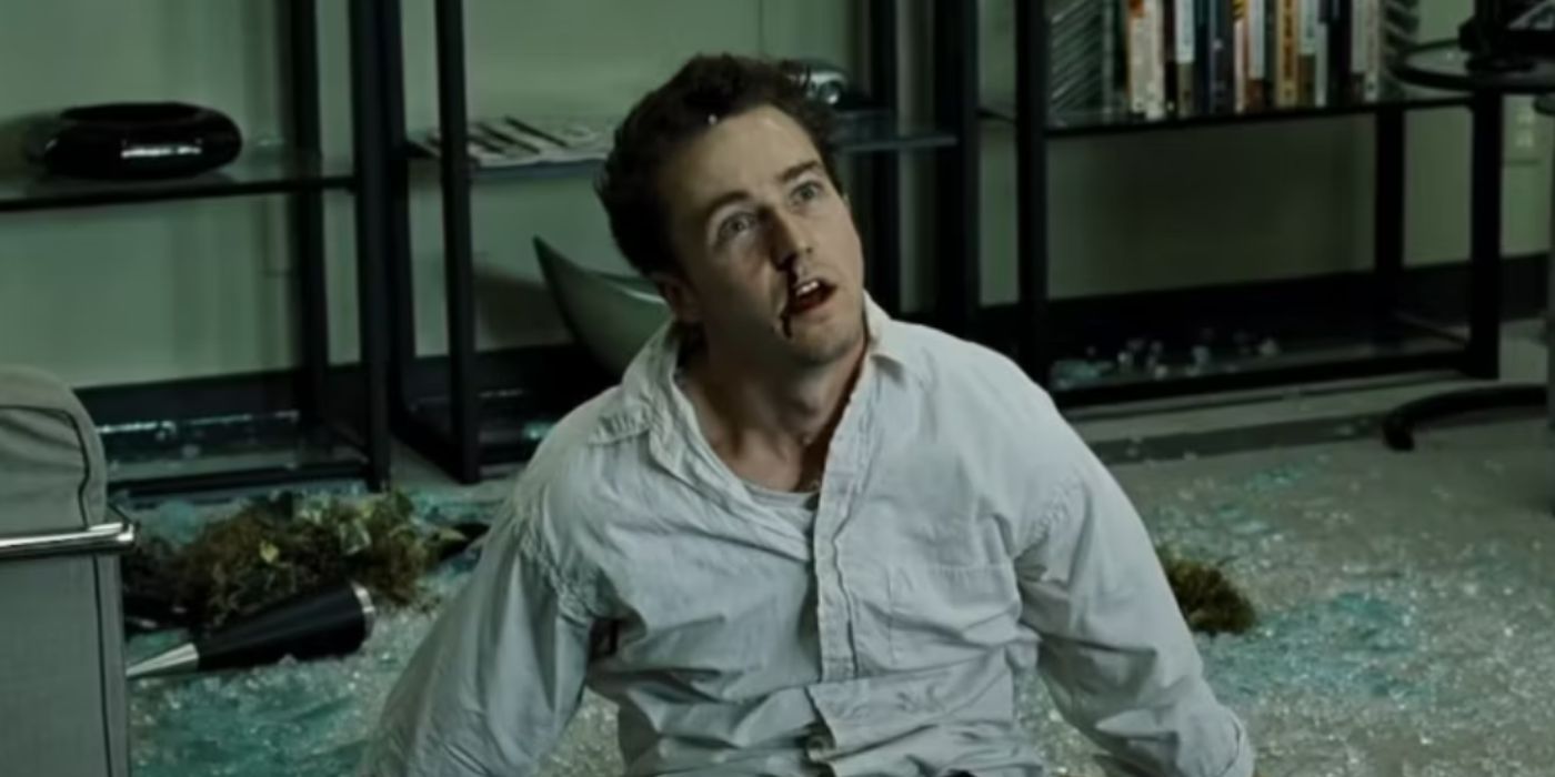 Edward Norton as The Narrator in Fight Club sitting in a destroyed apartment.