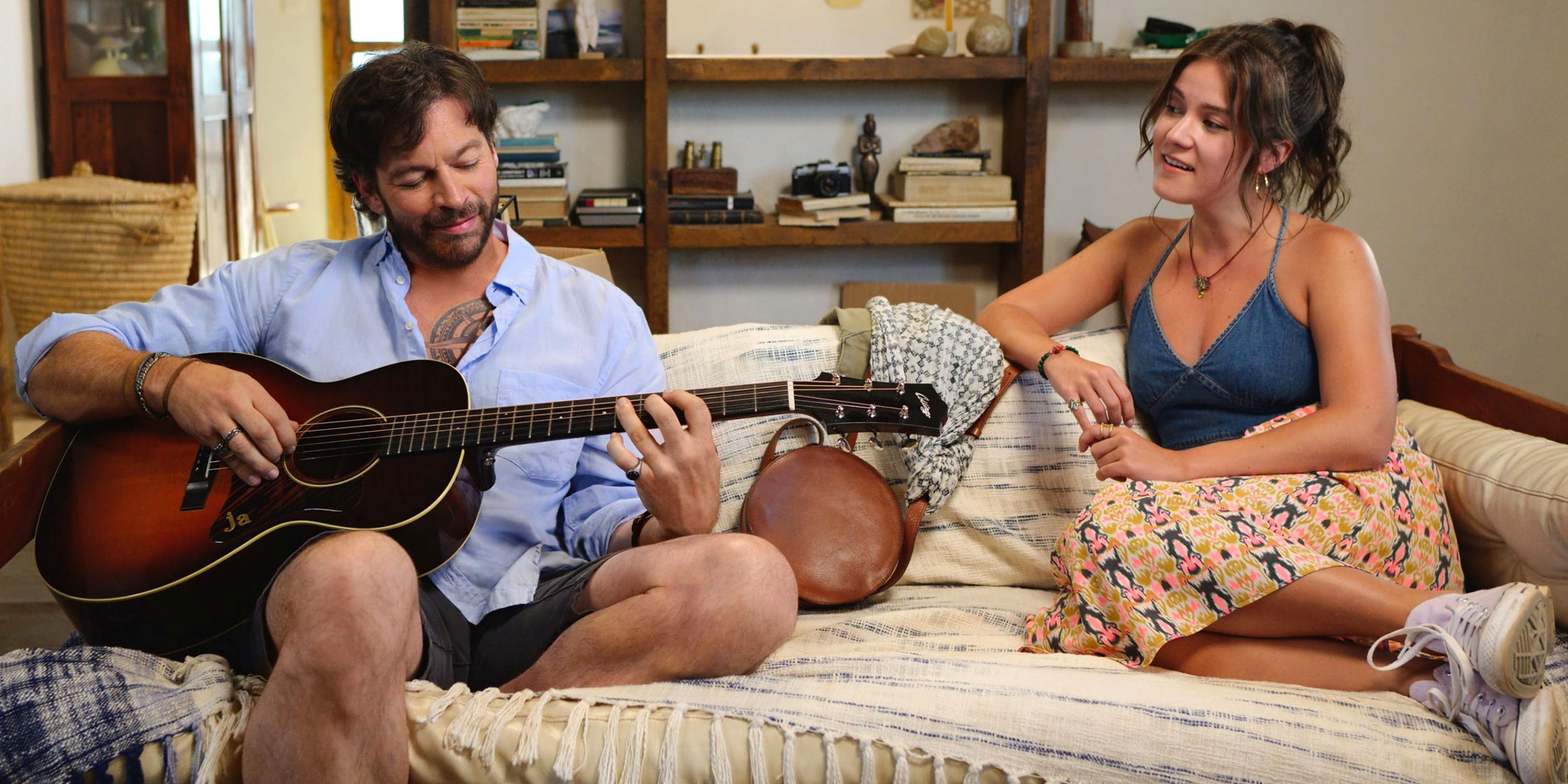 Ali Fumiko Whitney como Melina sentada en un sofá con Harry Connick Jr. tocando la guitarra en 