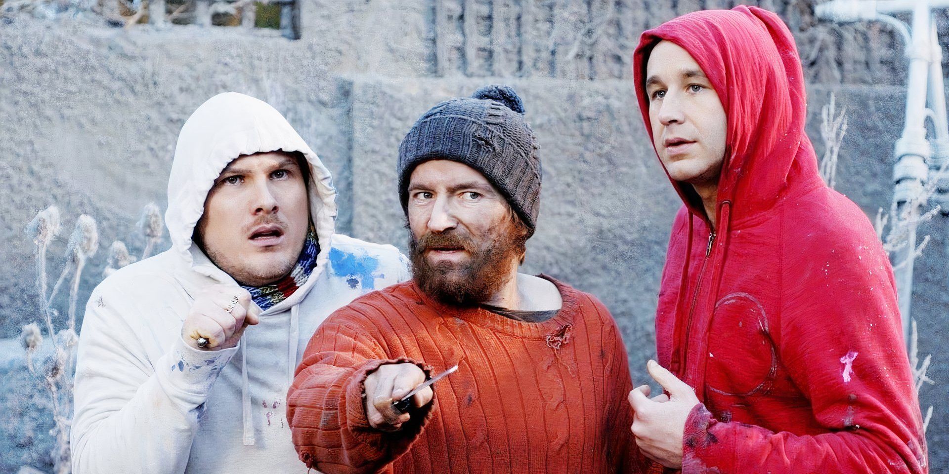 A trio of friends who have been stranded in the future, wearing dirtied hoodies and holding weapons in 'Frequently Asked Questions About Time Travel' (2009)