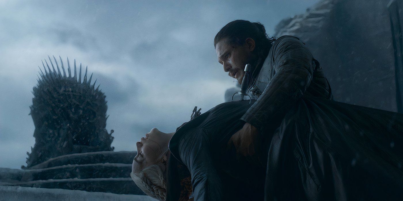 Jon Snow holding Daenerys Targaryen, slumped over in his arms in a scene from Game of Thrones