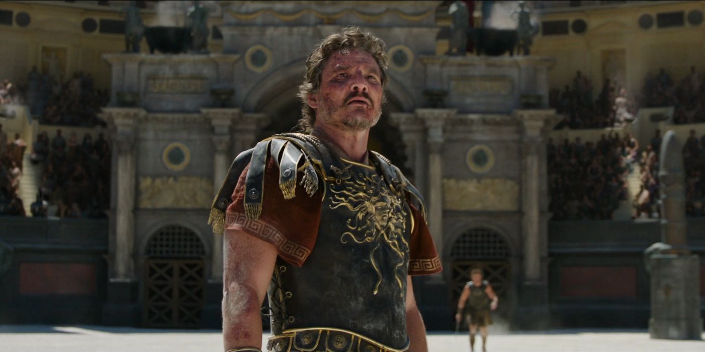 Pedro Pascal wearing Roman Armor as Marcus Acacius, standing in a colosseum looking up, in Gladiator II