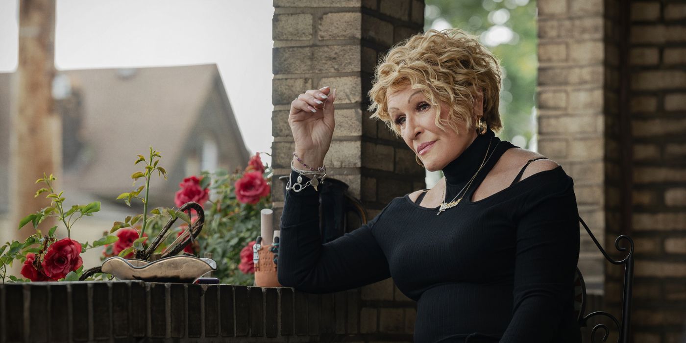 Alberta (Glenn Close) sitting on a front porch wearing a black dress in 'The Deliverance.'