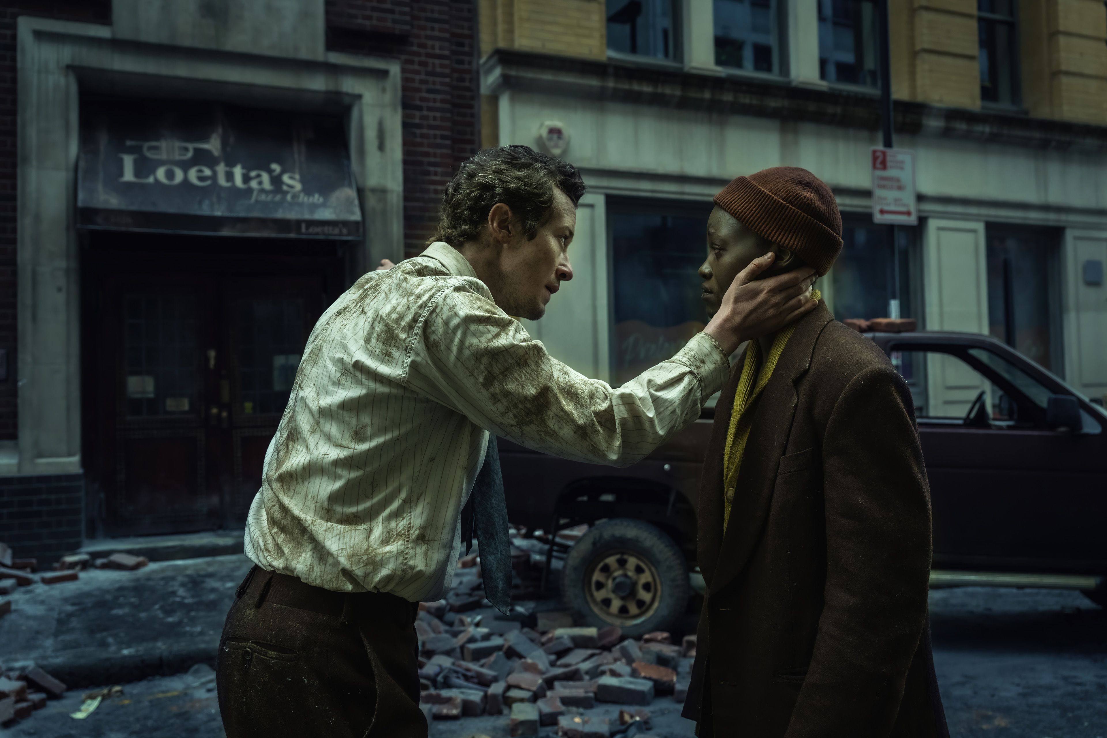 Eric, played by Joseph Quinn, comforts Sam, played by Lupita Nyong'o, amid the rubble of New York City in A Quiet Place: Day One