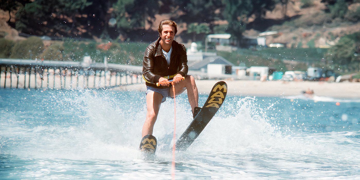 Fonzie from Happy Days water skiing while wearing swim trunks and a black leather jacket.