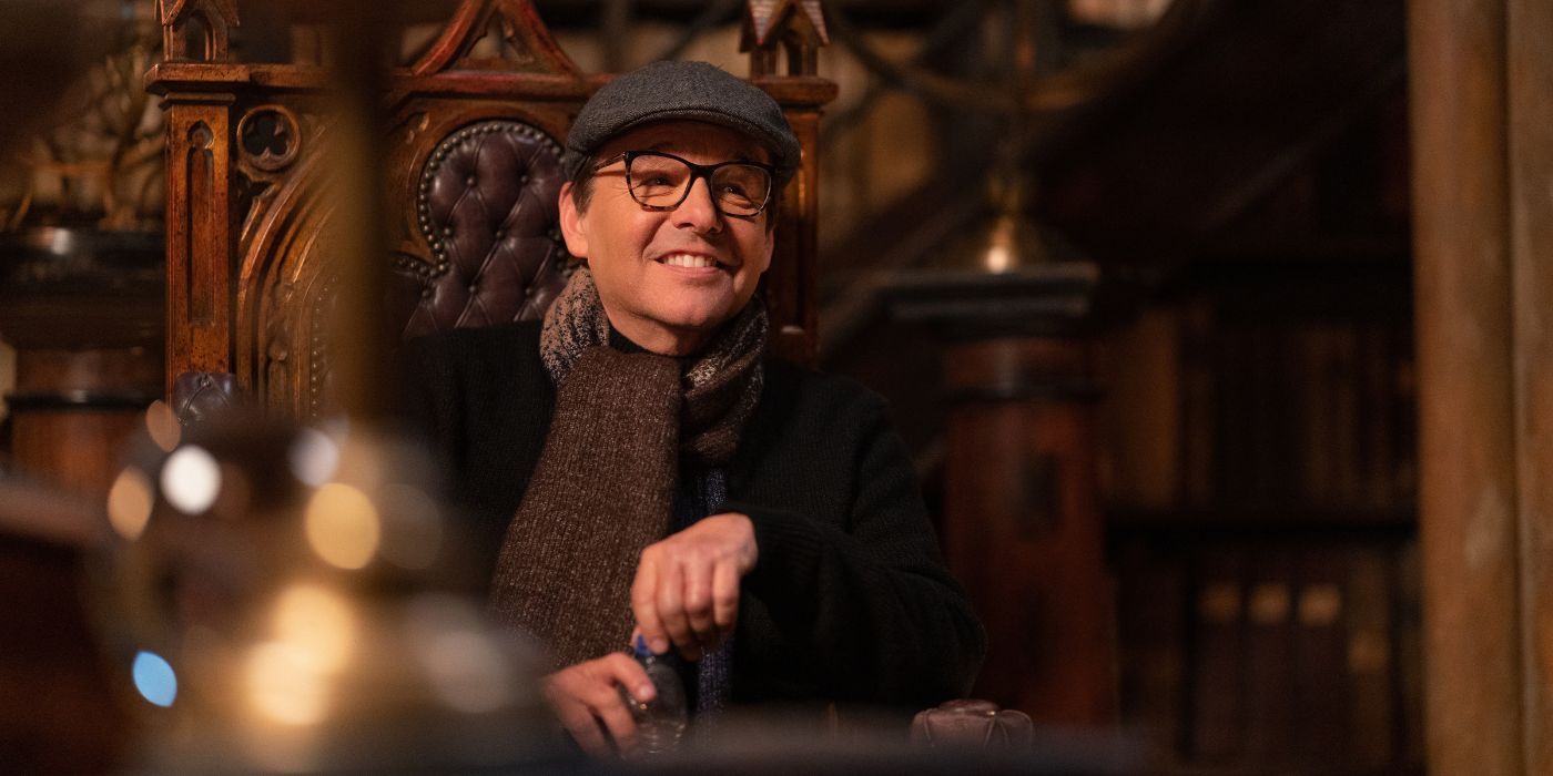 Chris Columbus sitting on a wooden chair in the Harry Potter 20th Anniversary special.
