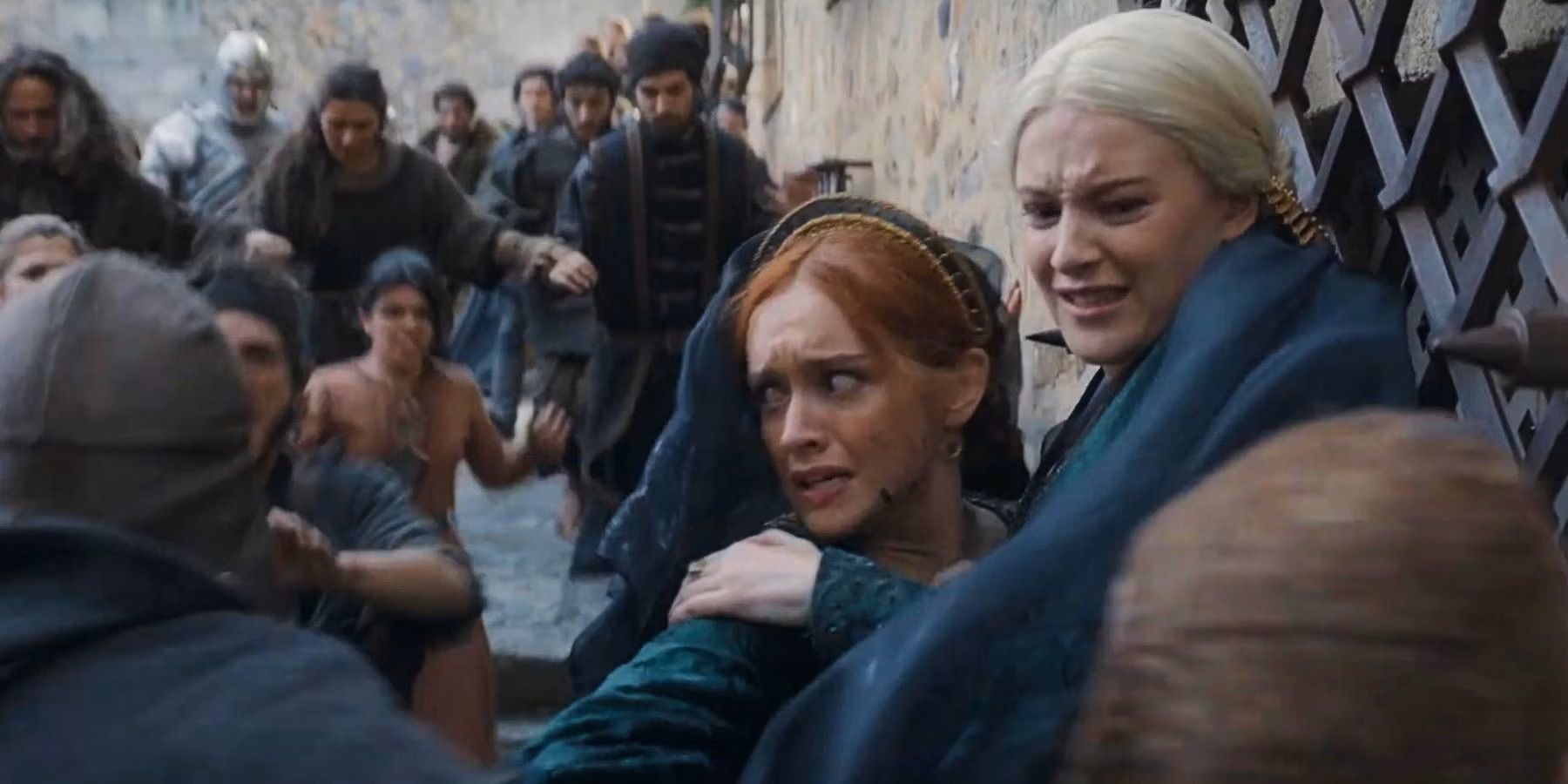 Alicent Hightower and Helaena Targaryen surrounded by angry people