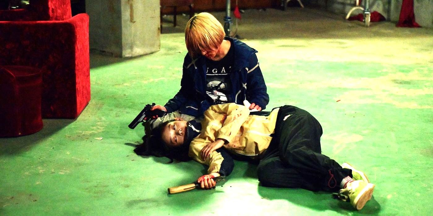 The two titular heroes rest on the ground in Baby Assassins: Nice Days.