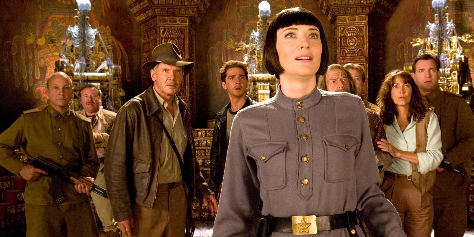 Indiana Jones, Irina Spalko, Marion Ravenwood, Mutt Williams, John Oxley, and Russian soldiers stand in the temple of Akator, surrounded by crystal skeletons in &lsquo;Kingdom of the Crystal Skull&rsquo;