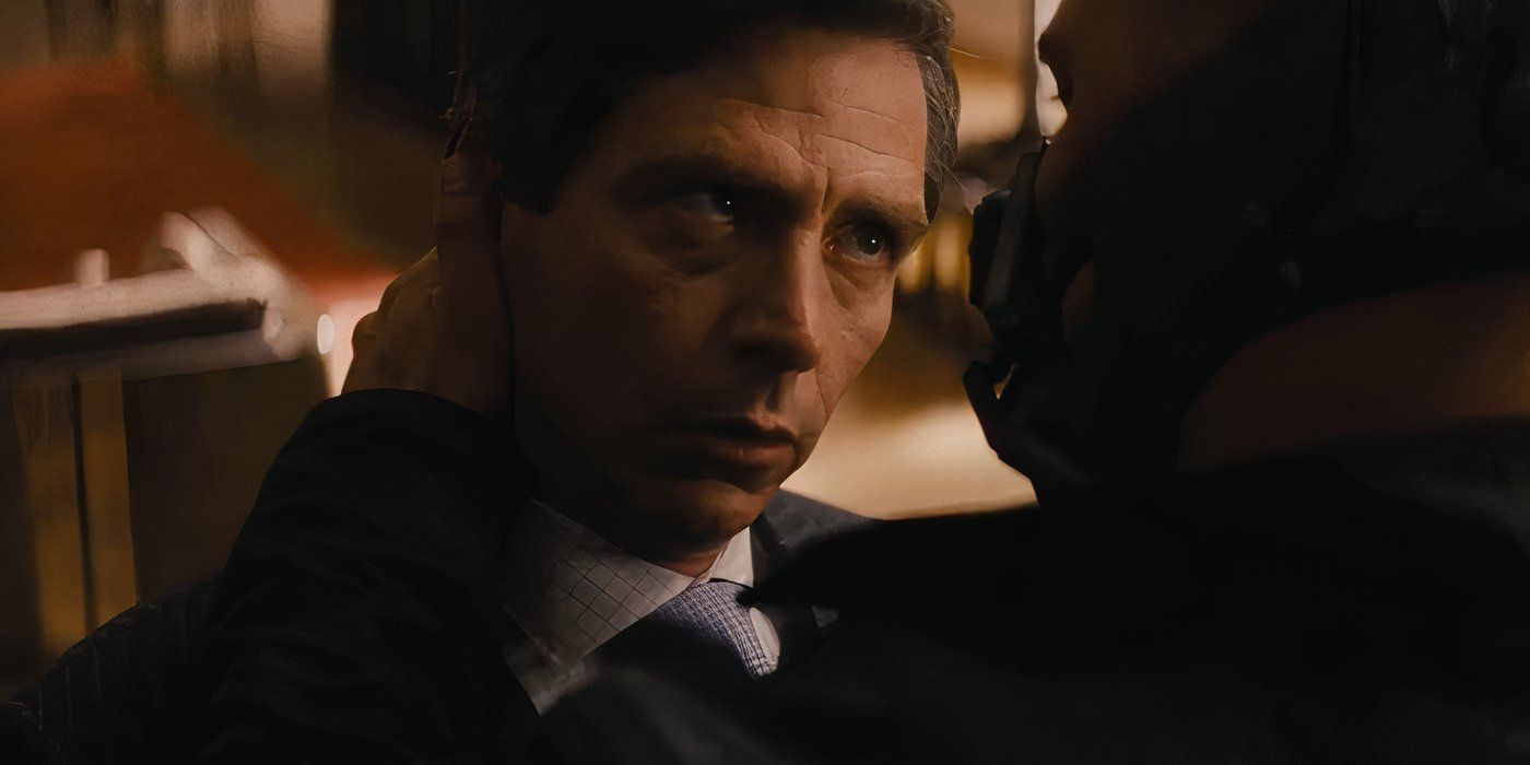 John Daggett beind held by Bane in The Dark Knight Rises