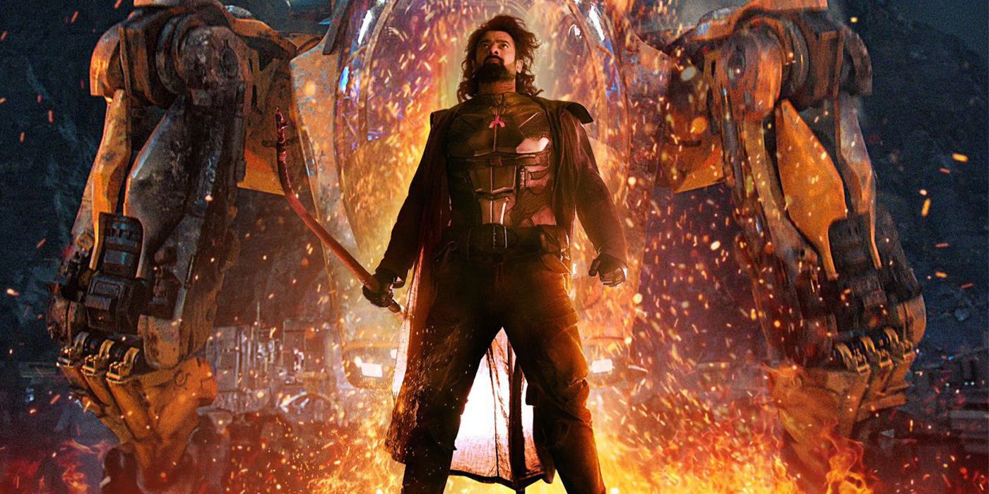 Prabhas holding a sword looking up surrounded by flames