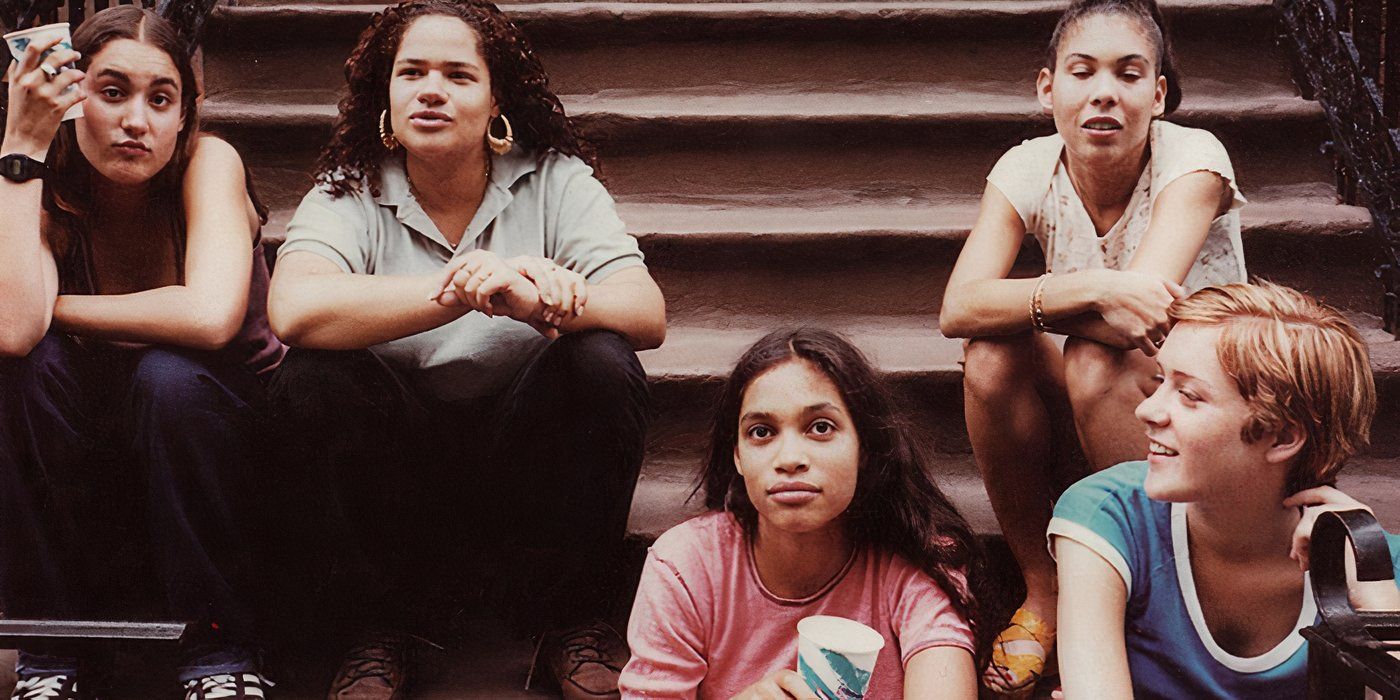 Five young girls sit on a stoop laughing in the 1995 movie Kids.