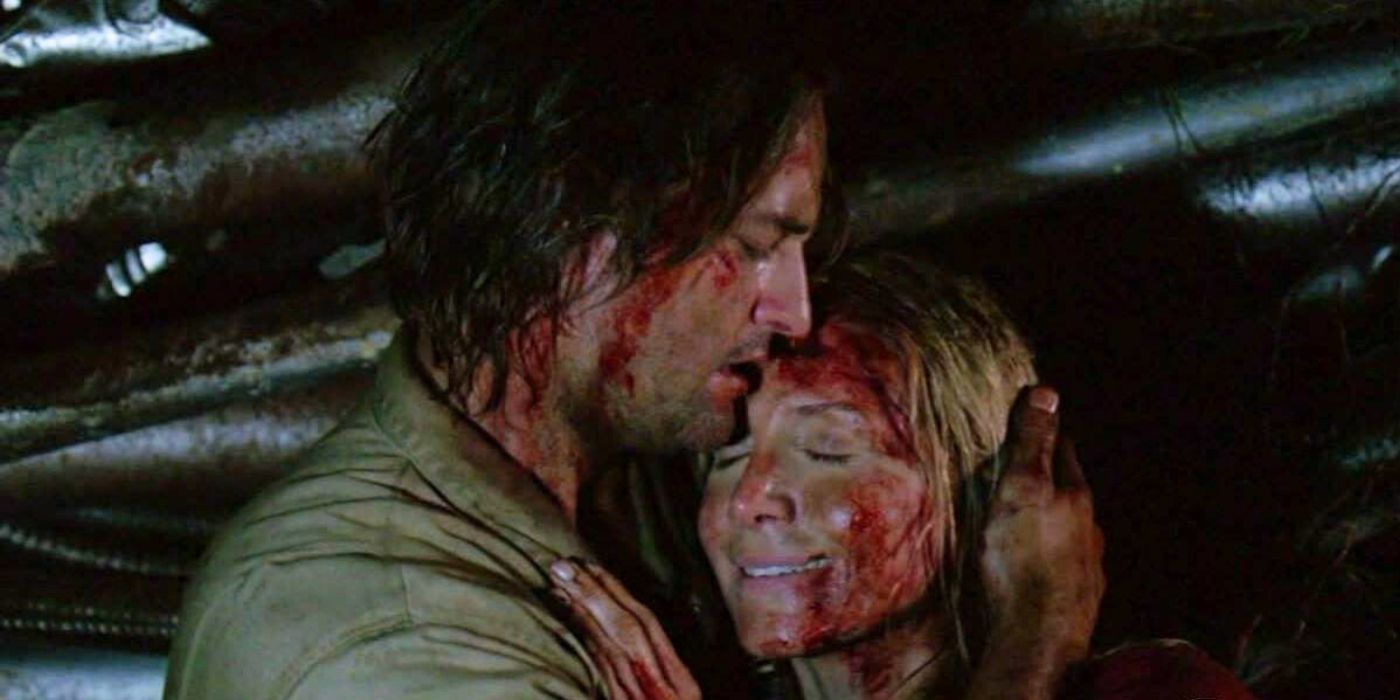 Josh Holloway and Elizabeth Mitchell, bloody and holding each other in Lost.
