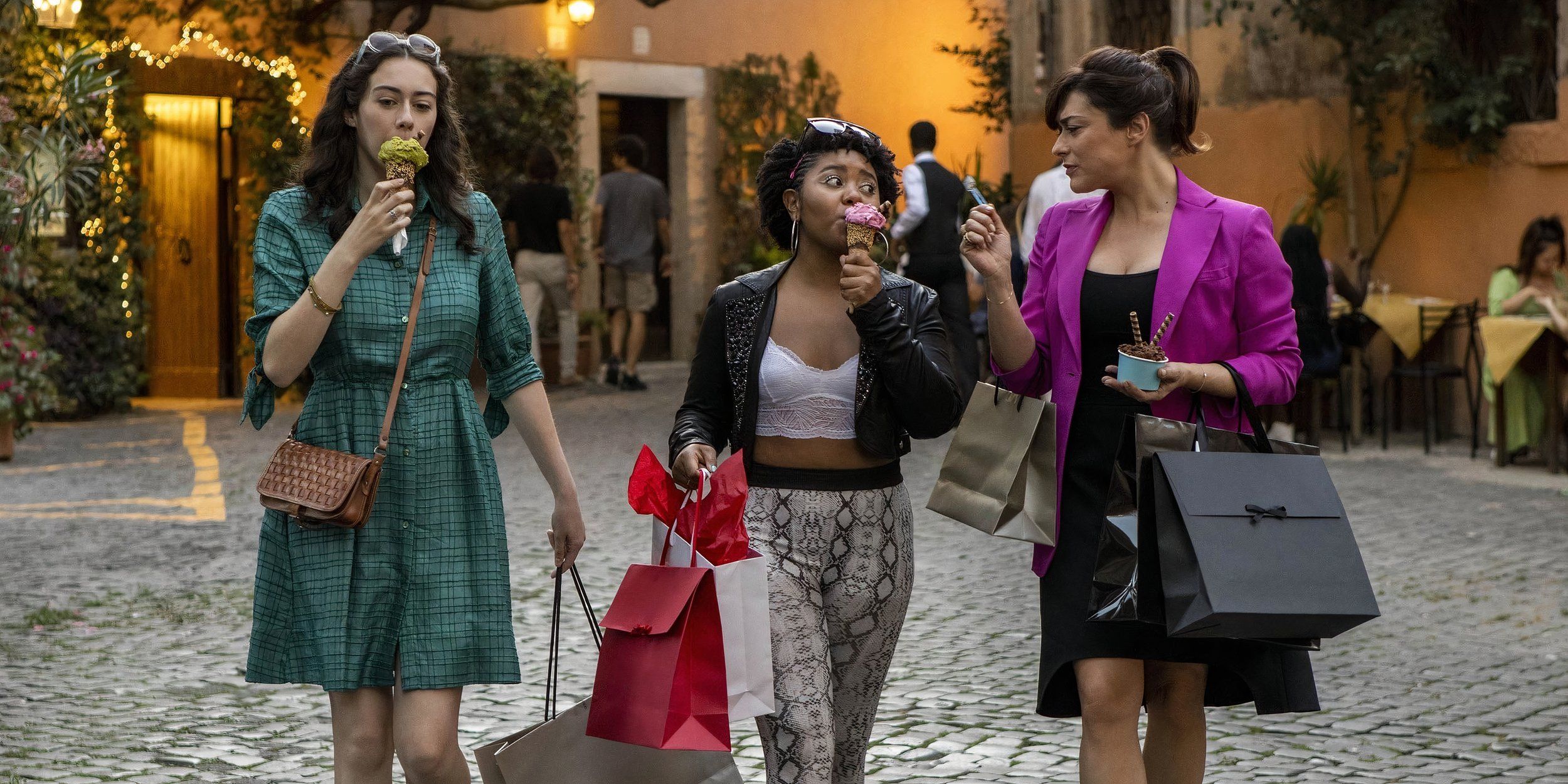 A trio of women walking down the street while holding shopping bags and eating gelato in 'Love & Gelato' (2022)